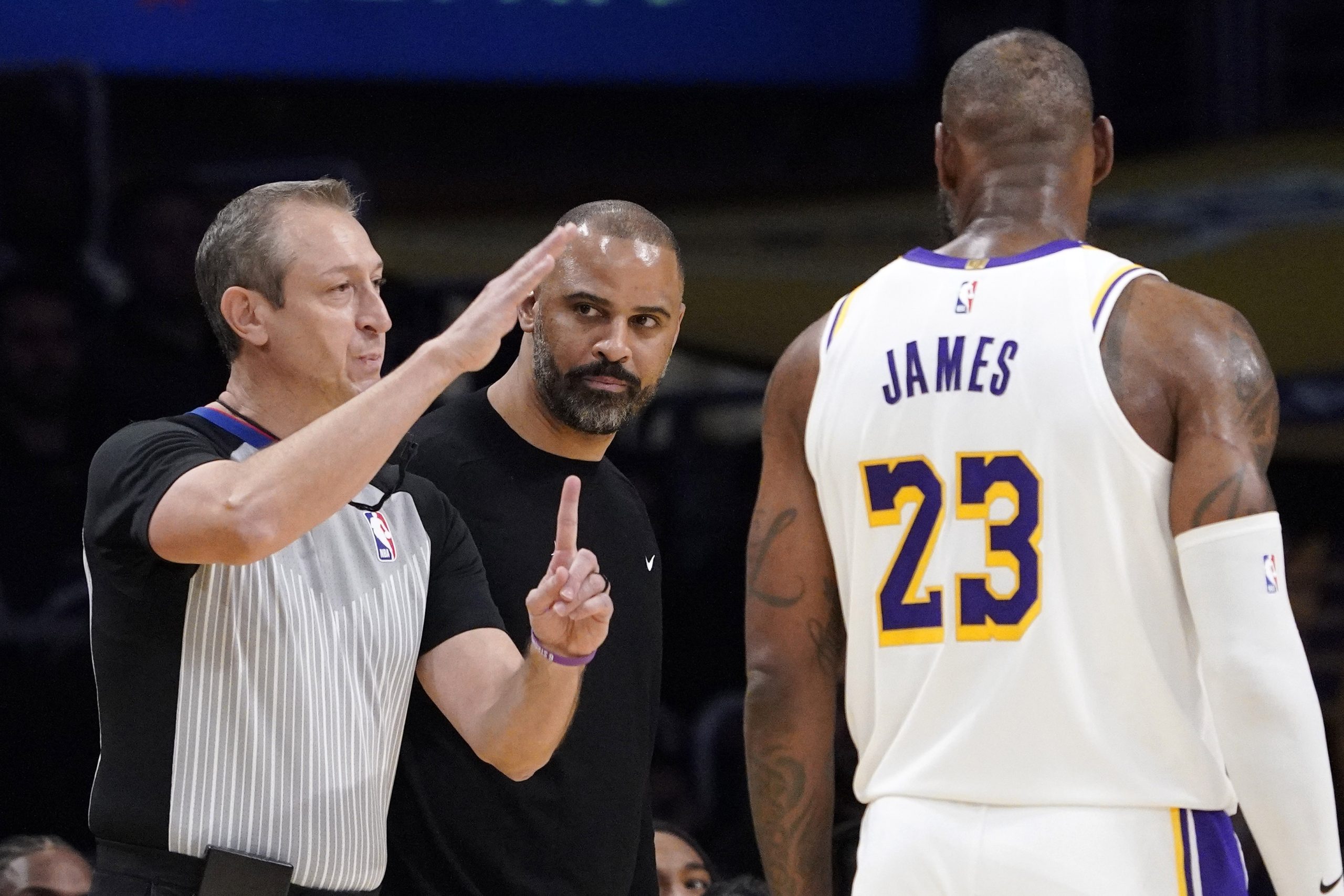Referee J.T. Orr, left, assesses technical fouls to Houston Rockets...