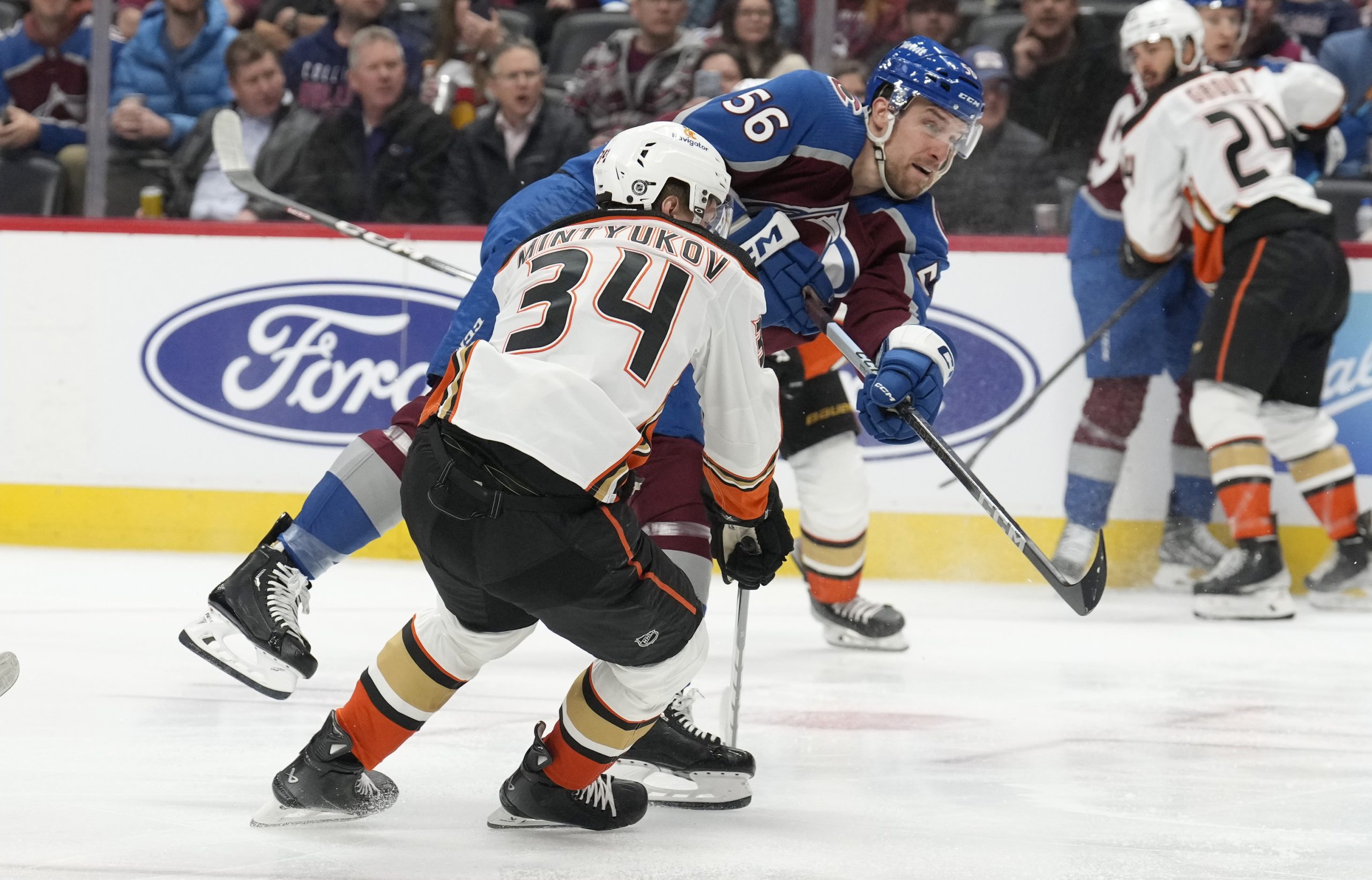 Colorado Avalanche defenseman Kurtis MacDermid, back, shoots the puck for...