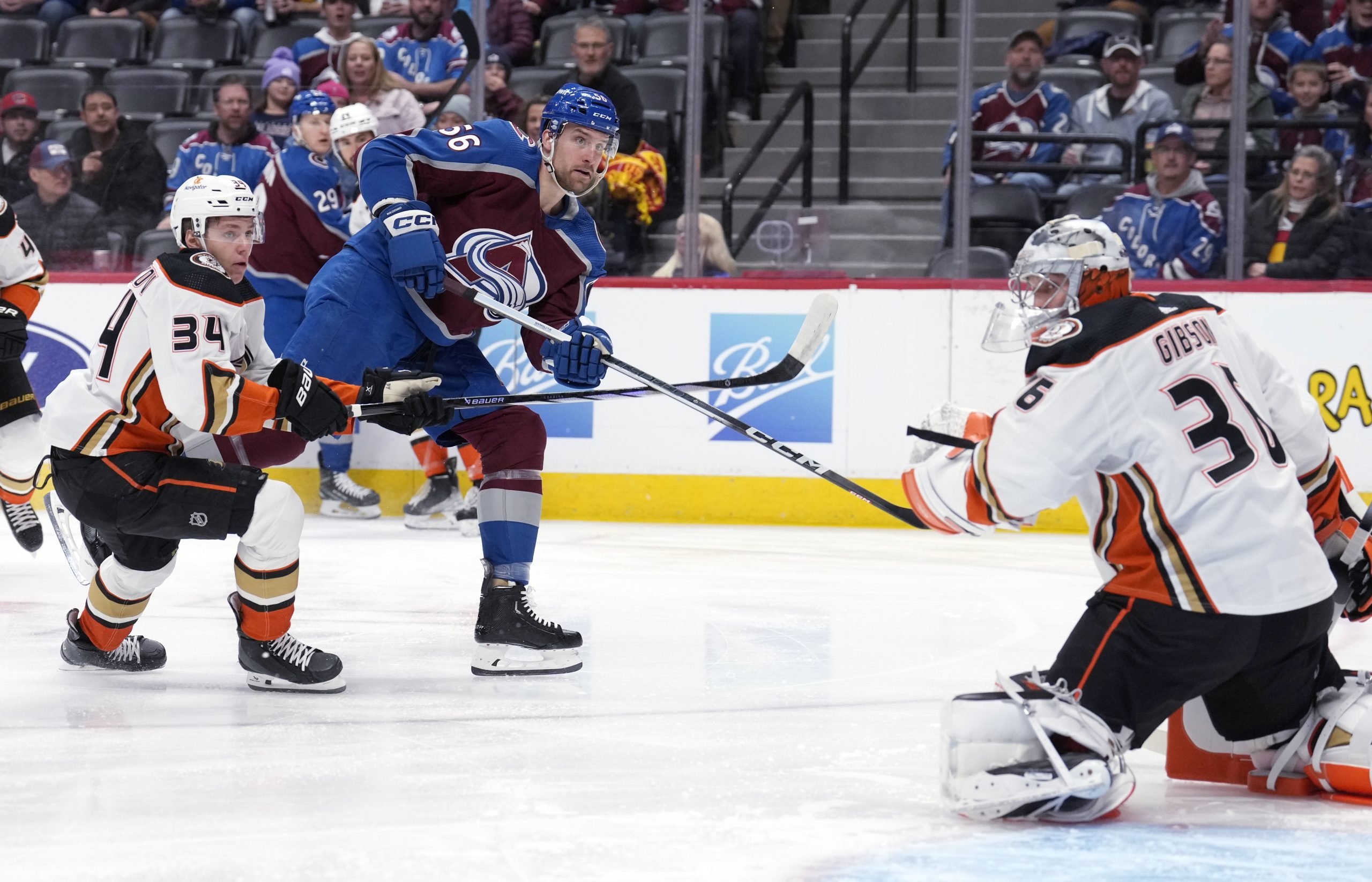 Colorado Avalanche defenseman Kurtis MacDermid, center, shoots the puck for...