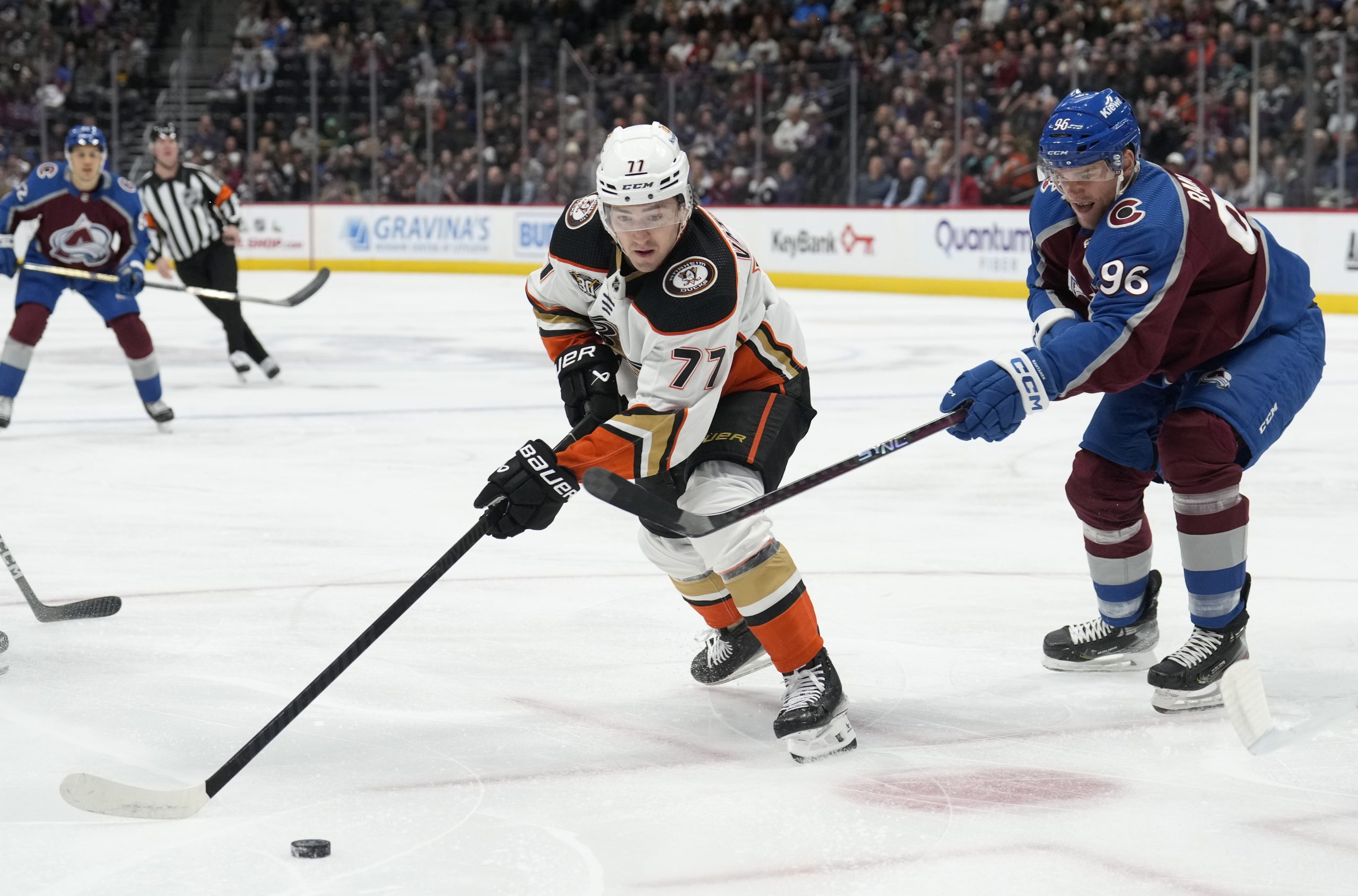 Ducks right wing Frank Vatrano, left, collects the puck as...