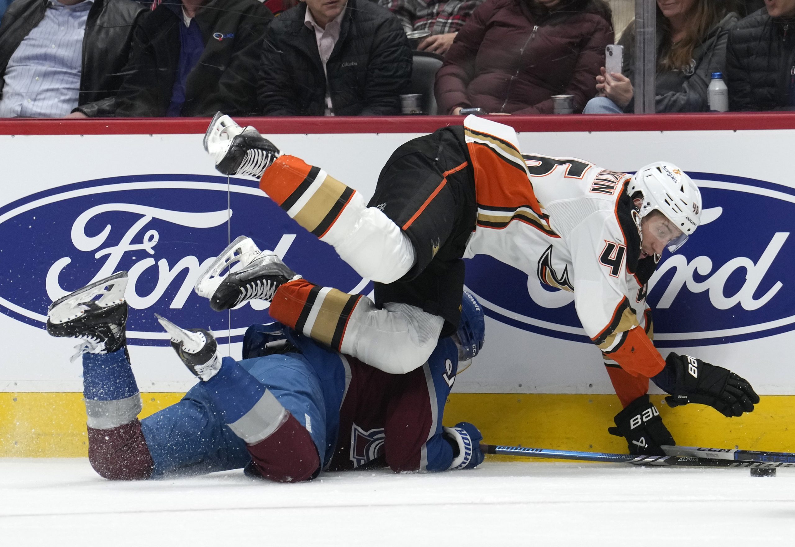 Ducks defenseman Ilya Lyubushkin, right, tumbles over Colorado Avalanche right...