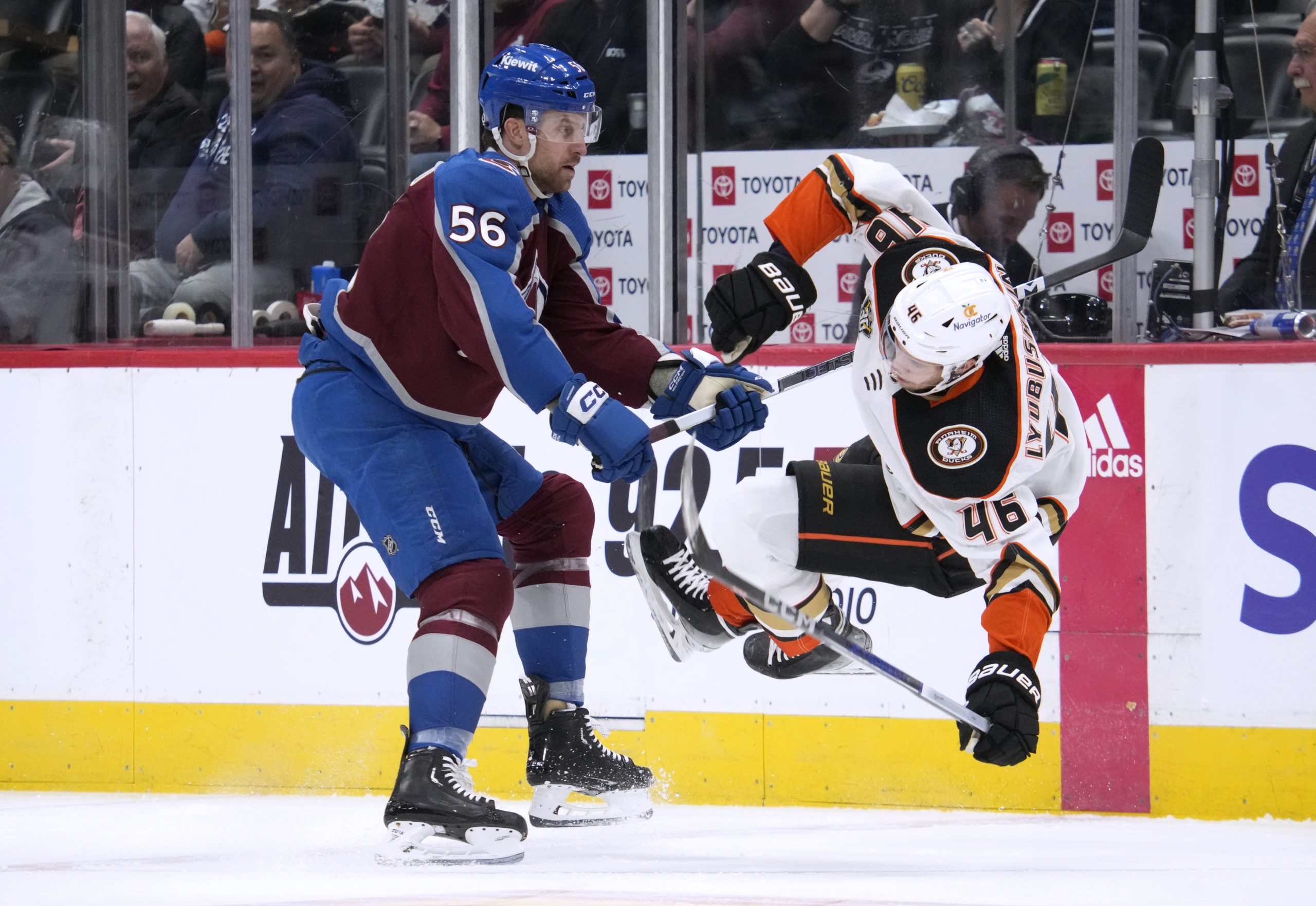 Colorado Avalanche defenseman Kurtis MacDermid, left, knocks Ducks defenseman Ilya...