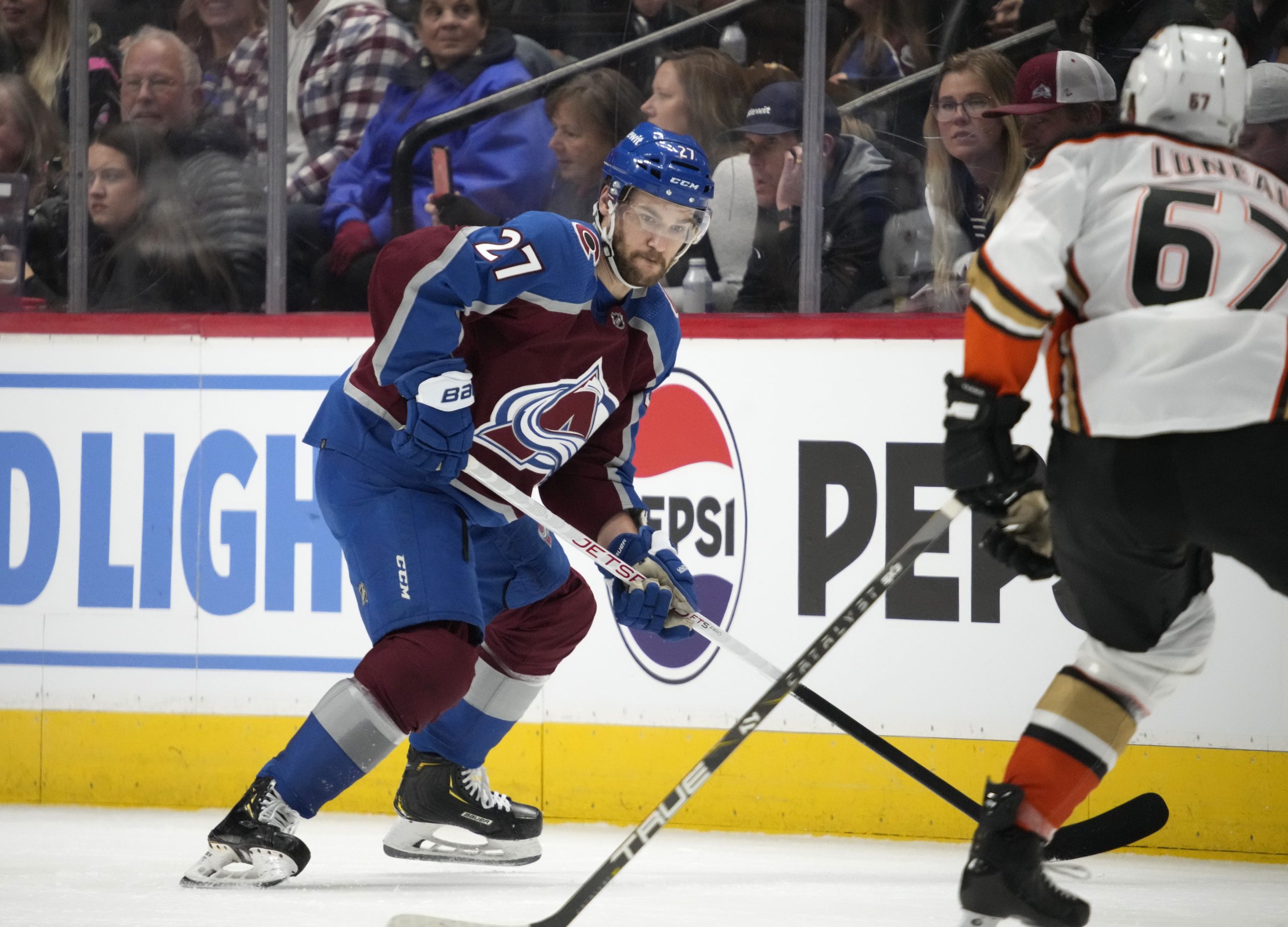 Colorado Avalanche left wing Jonathan Drouin, left, looks to pass...