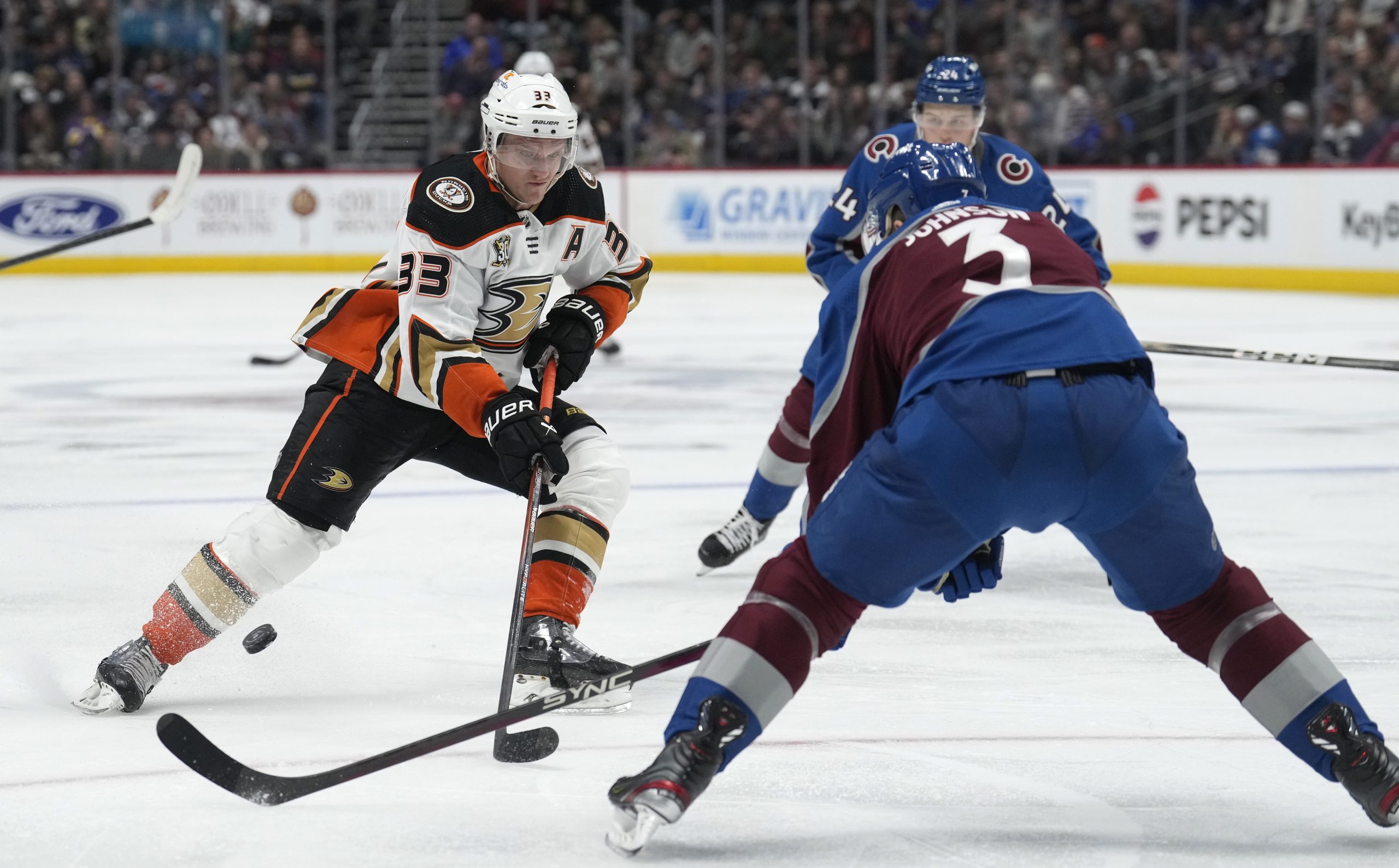 Ducks right wing Jakob Silfverberg, left, loses control of the...