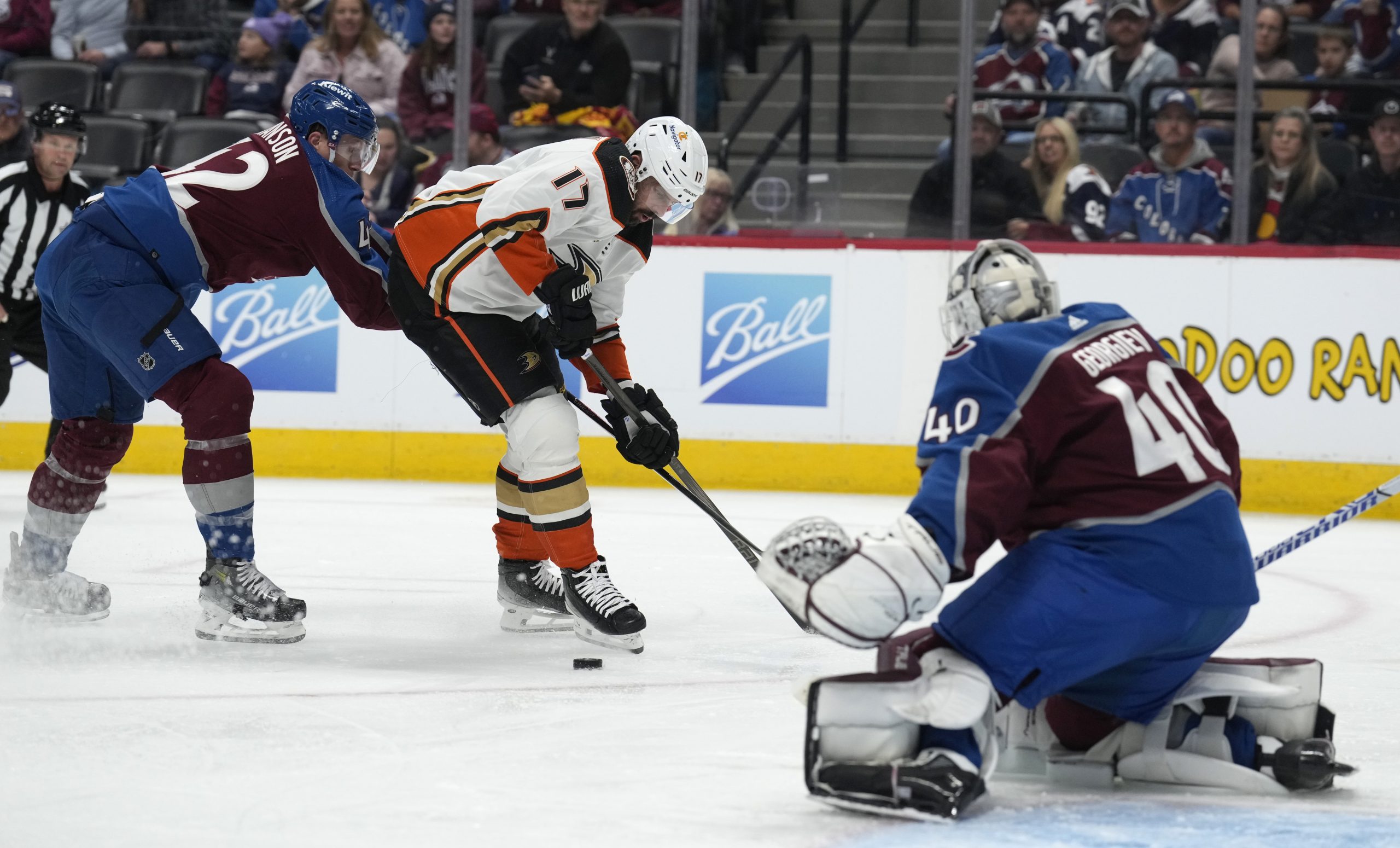 Ducks left wing Alex Killorn, center, loses control of the...