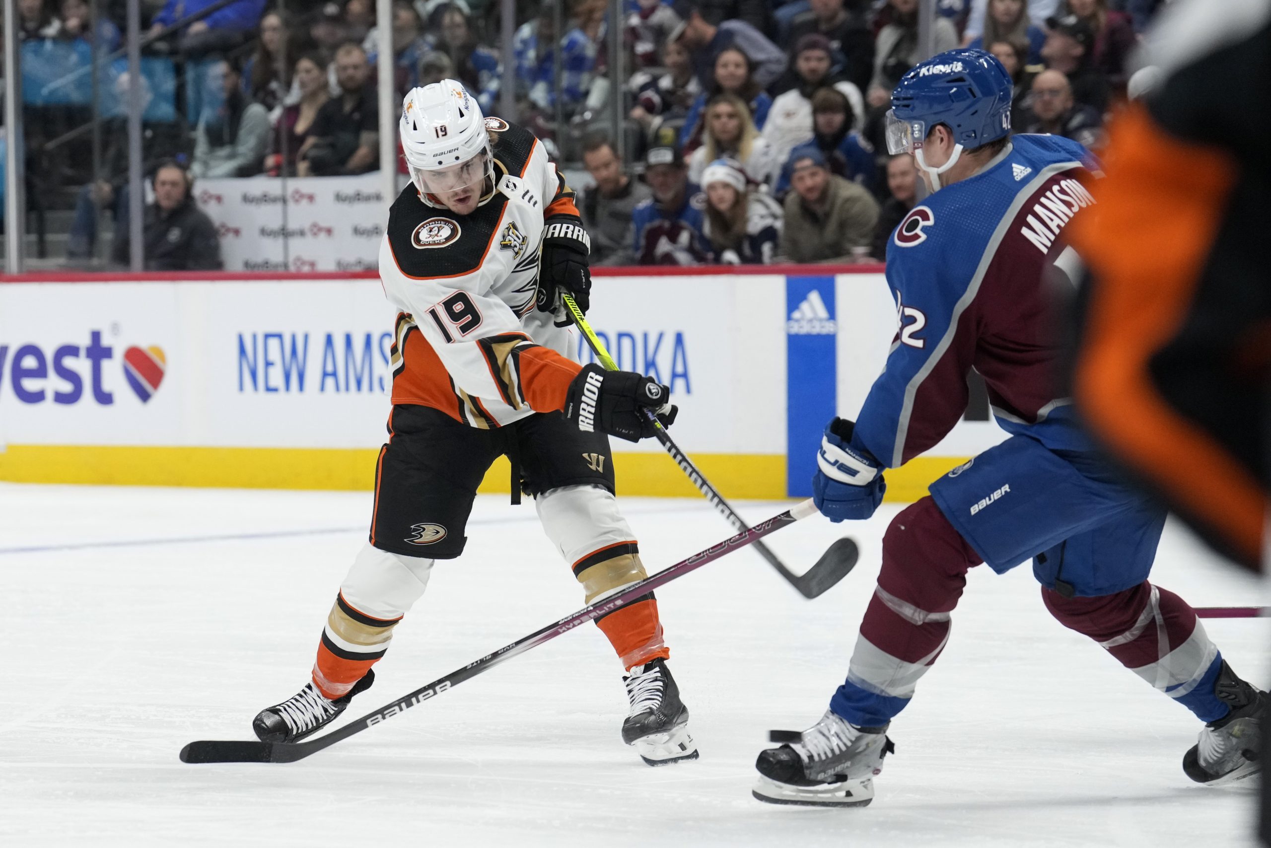 Ducks right wing Troy Terry, left, shoots the puck past...