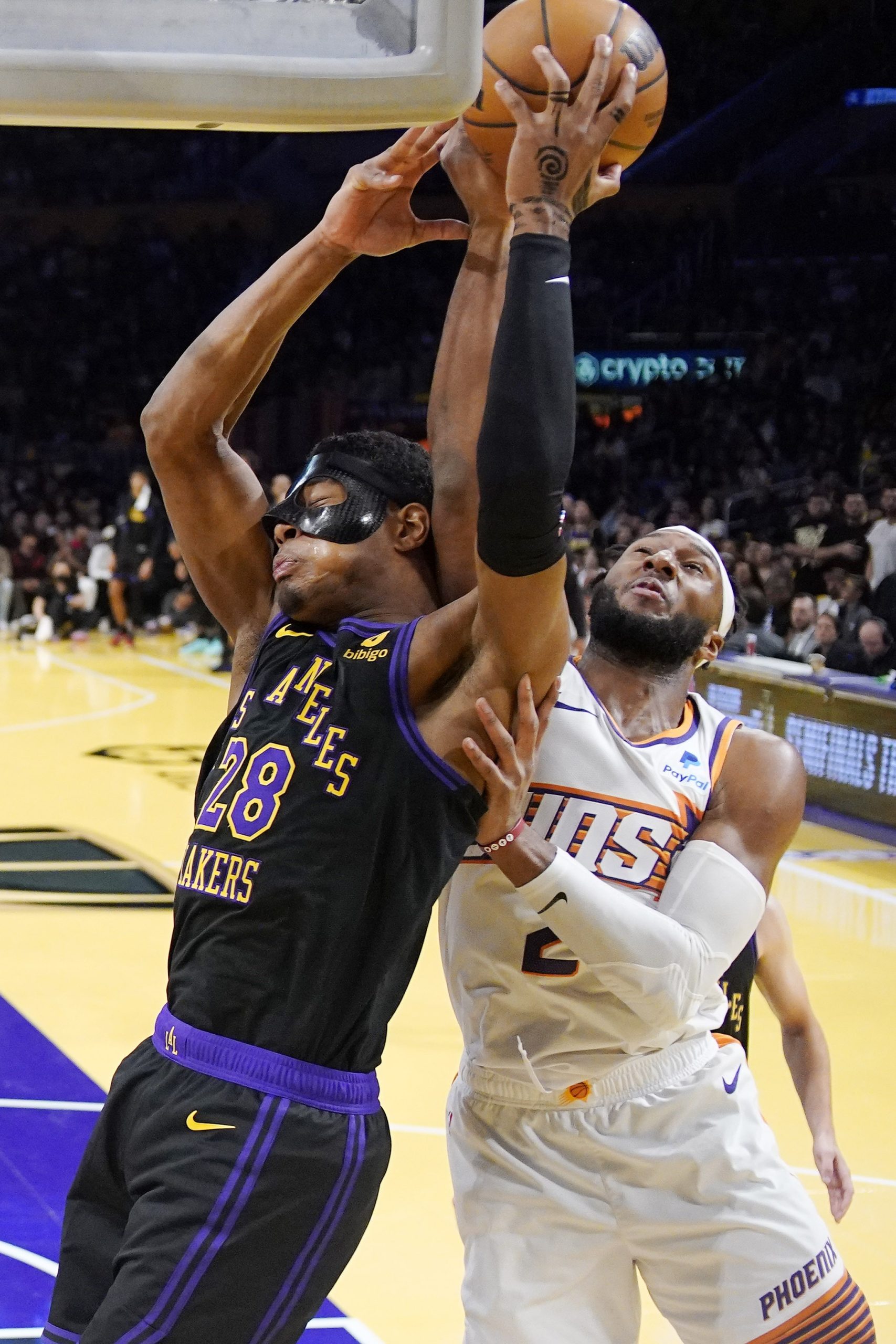 Lakers forward Rui Hachimura, left, and Phoenix Suns forward Josh...