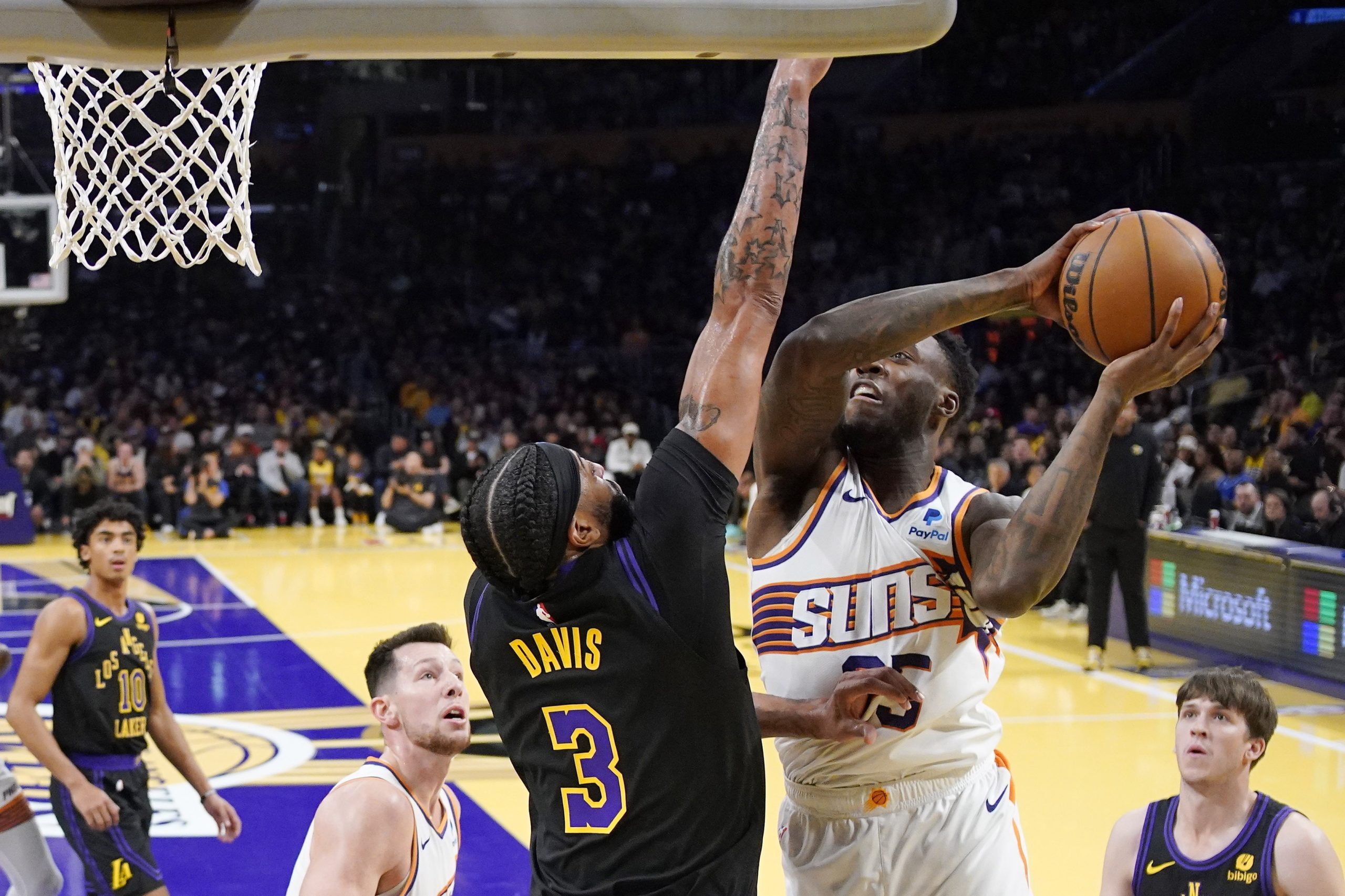 Phoenix Suns forward Nassir Little, right, shoots as Lakers forward...