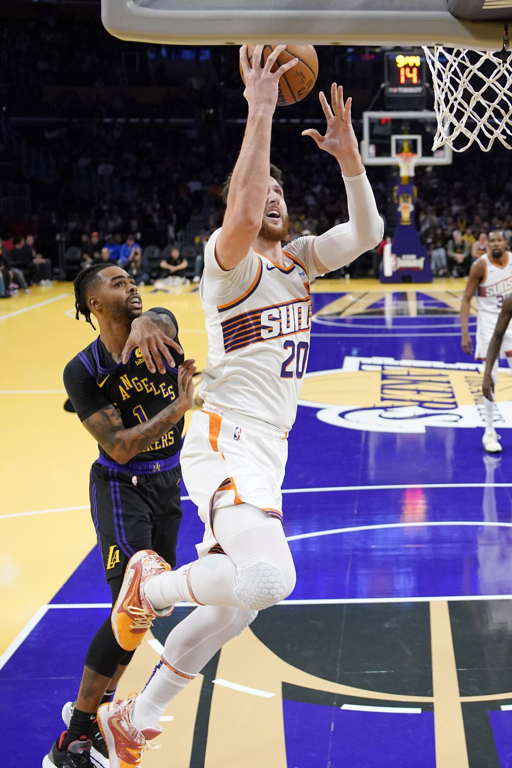 Phoenix Suns center Jusuf Nurkic, right, shoots as Lakers guard...