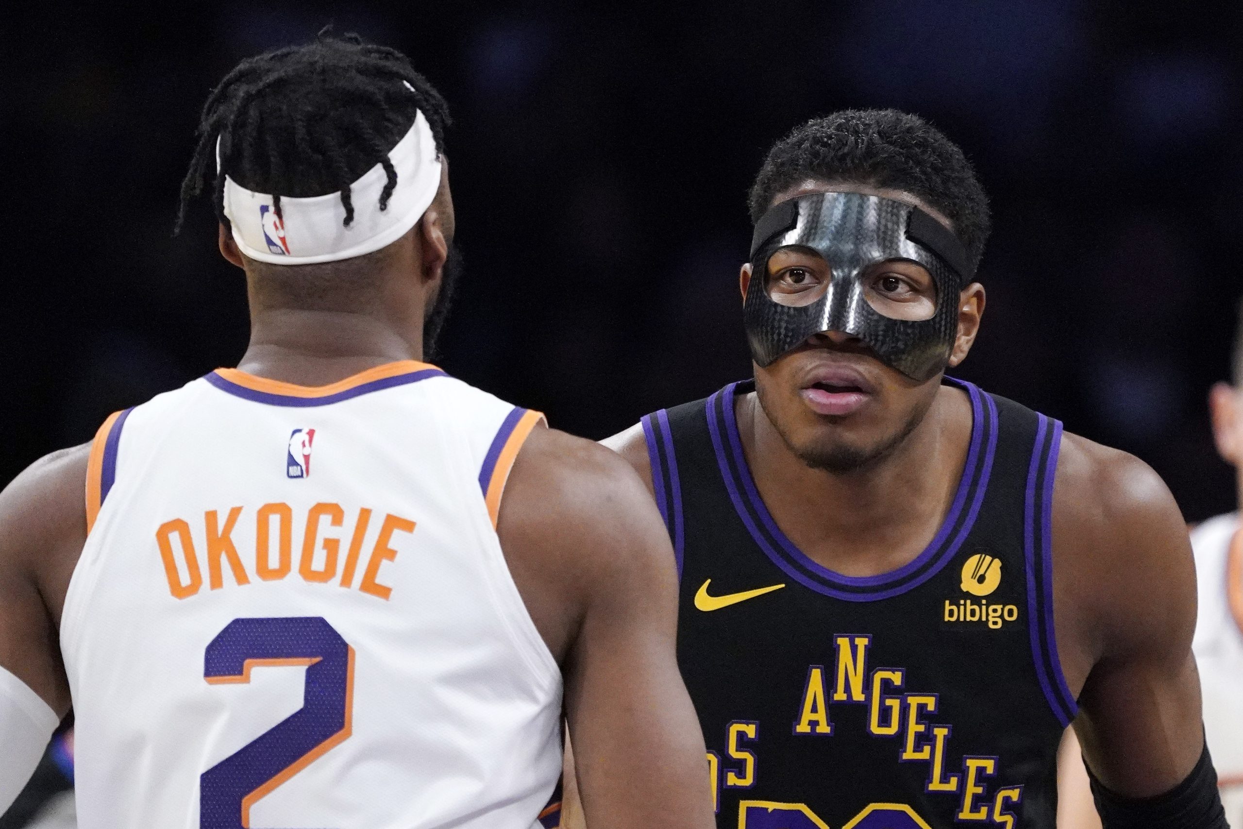 Lakers forward Rui Hachimura, right, faces off against Phoenix Suns...