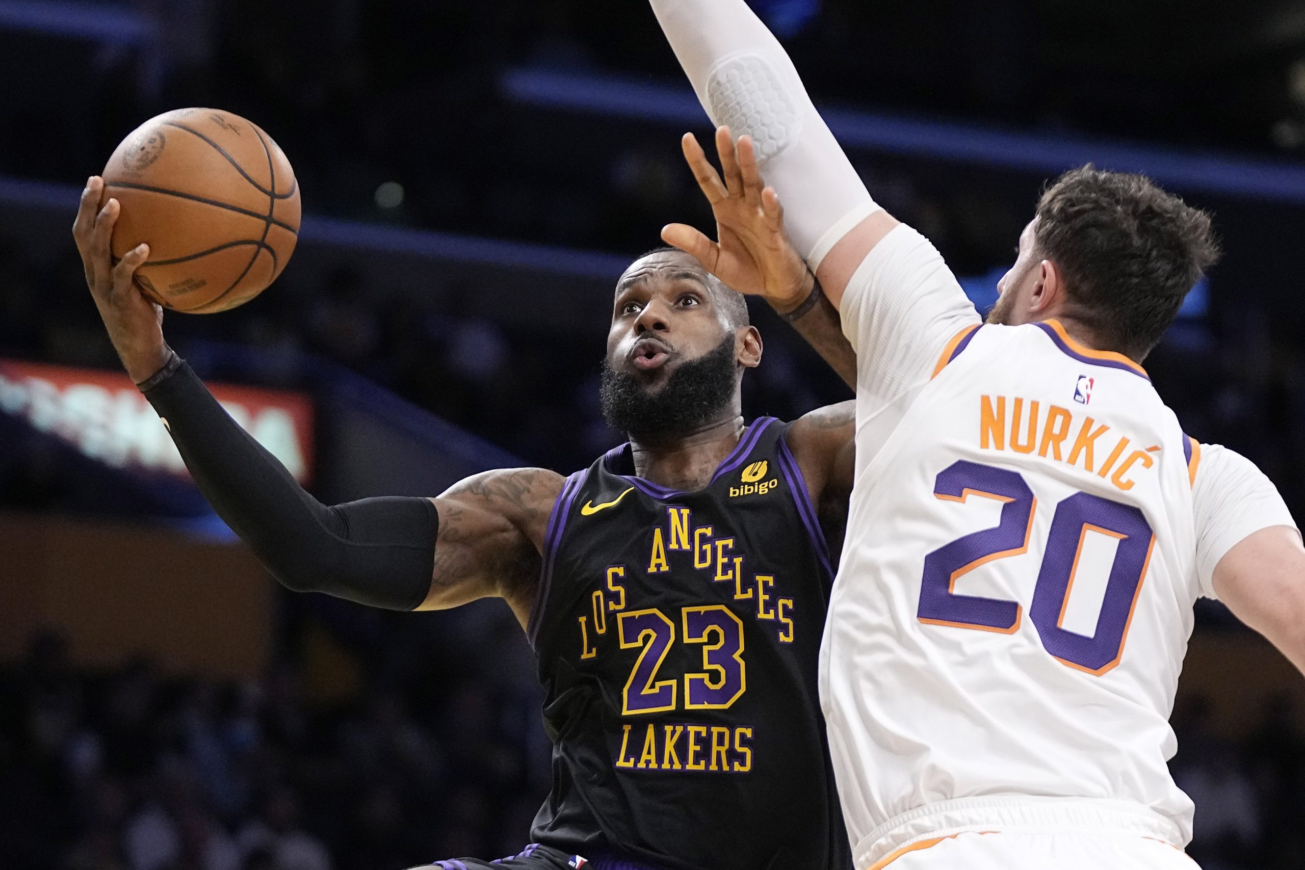 Lakers forward LeBron James shoots as Phoenix Suns center Jusuf...