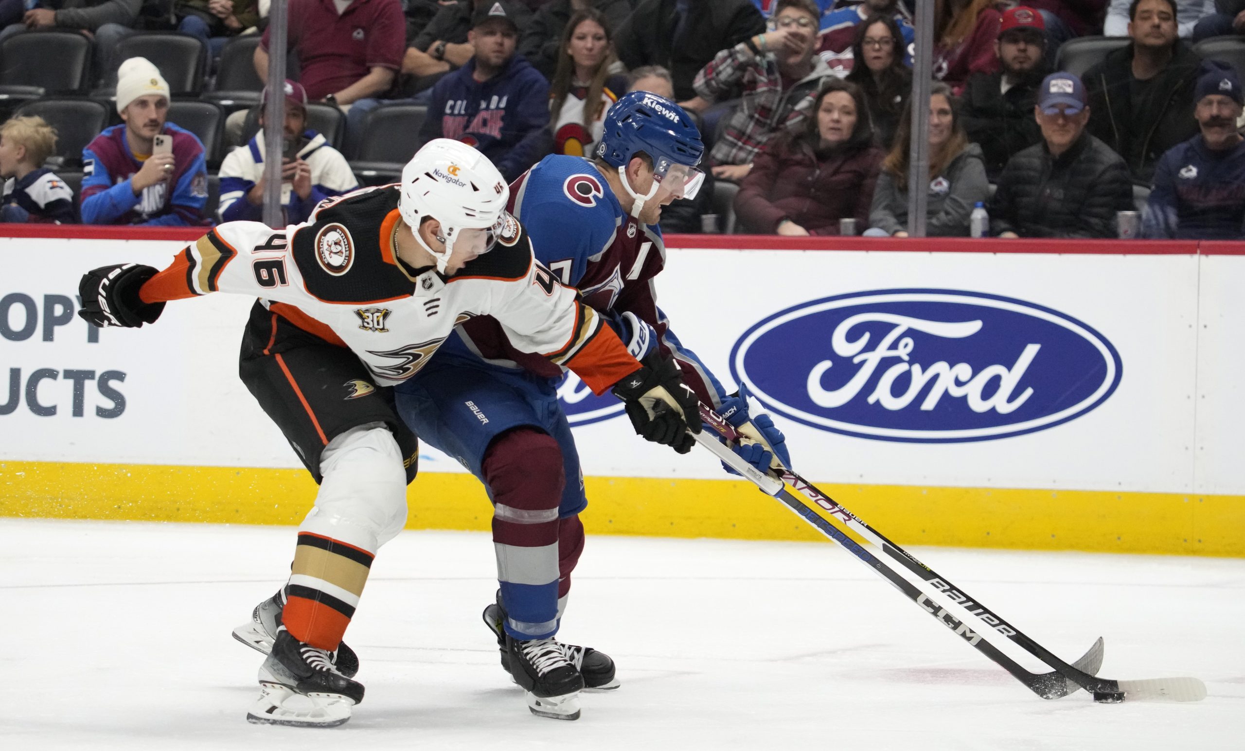 Ducks defenseman Ilya Lyubushkin, left, ties up Colorado Avalanche defenseman...