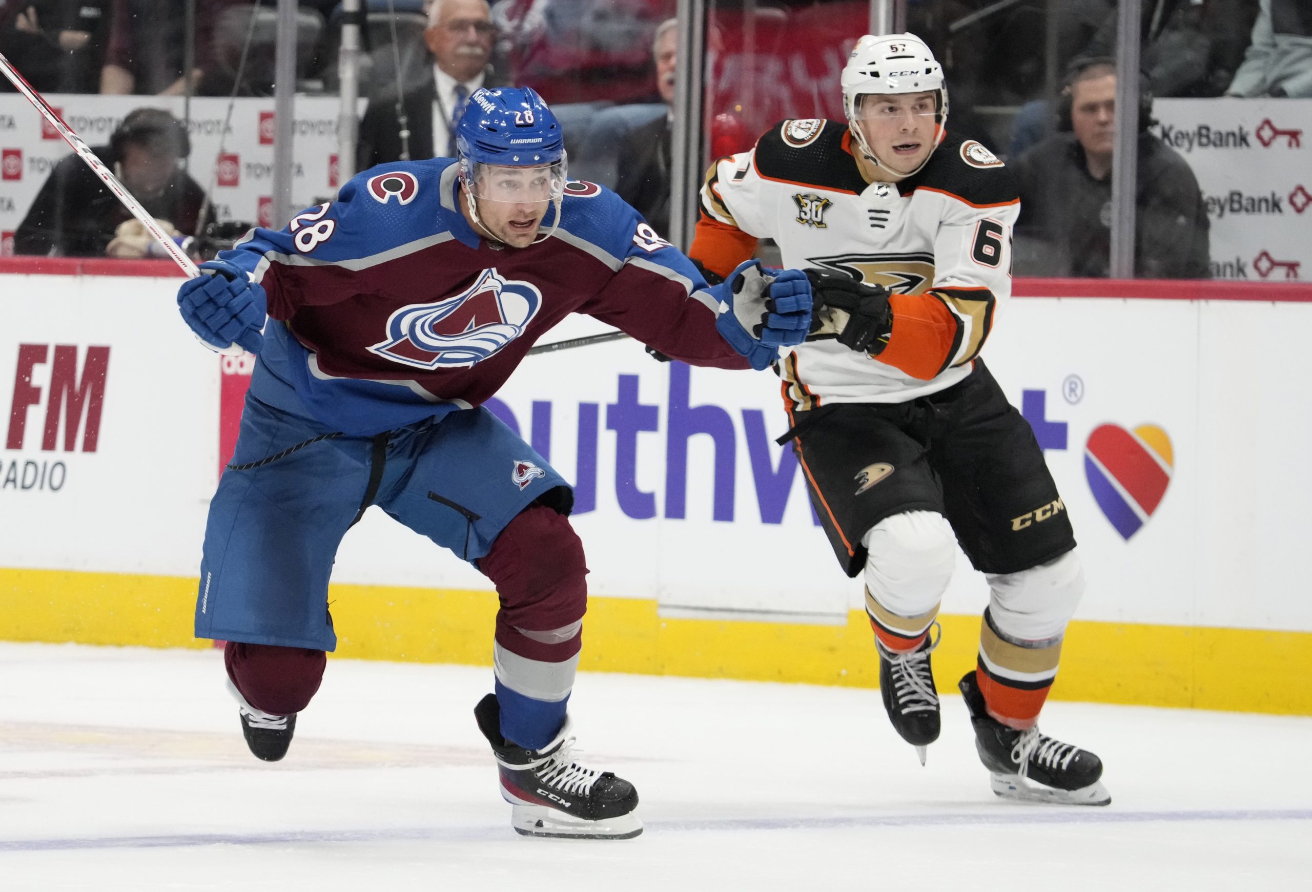 Colorado Avalanche left wing Miles Wood, left, drives past Ducks...