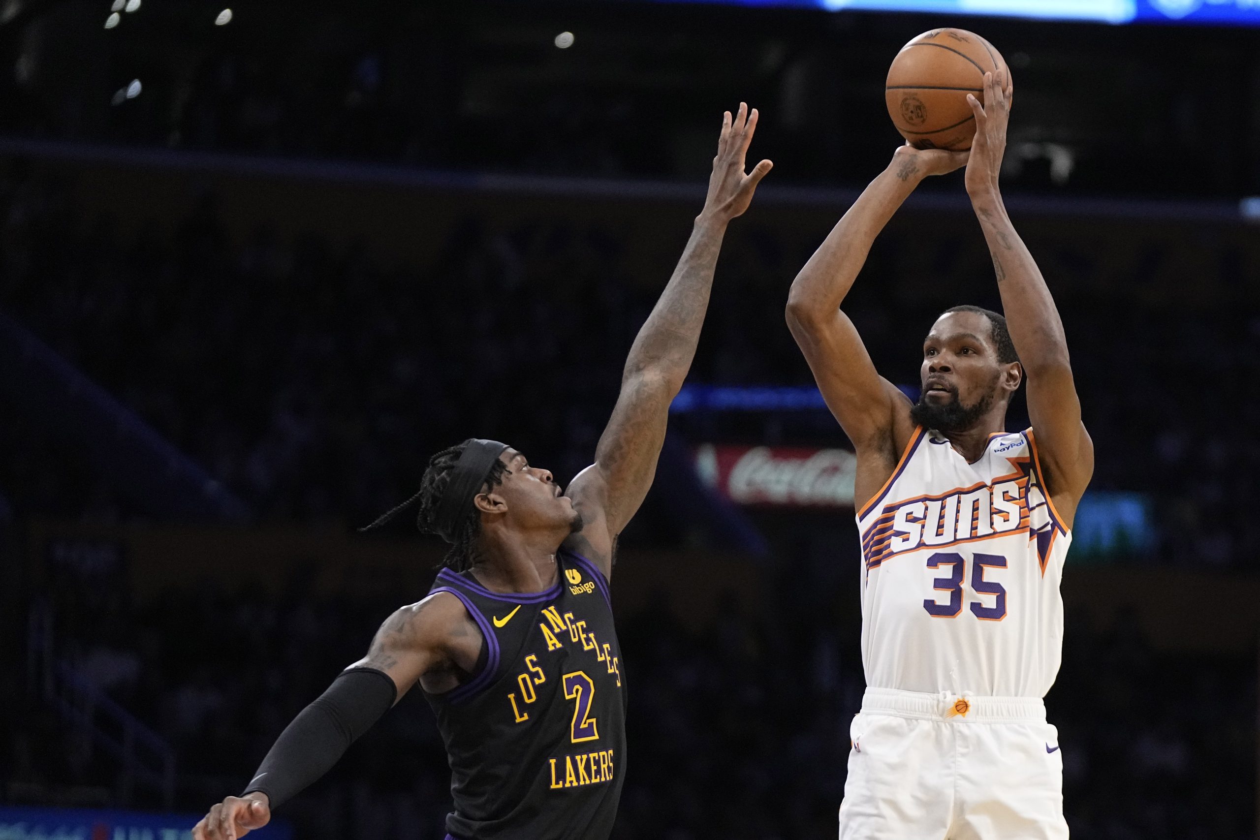 Phoenix Suns forward Kevin Durant, right, shoots as Lakers forward...