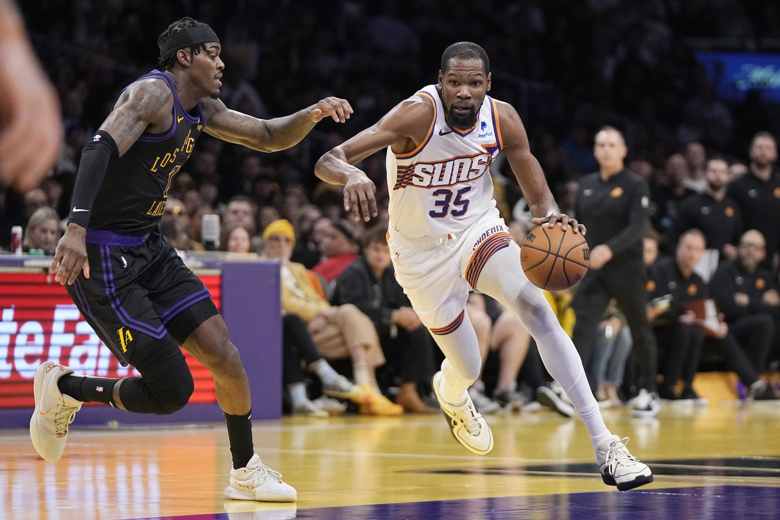 Phoenix Suns forward Kevin Durant, right, drives toward the basket...