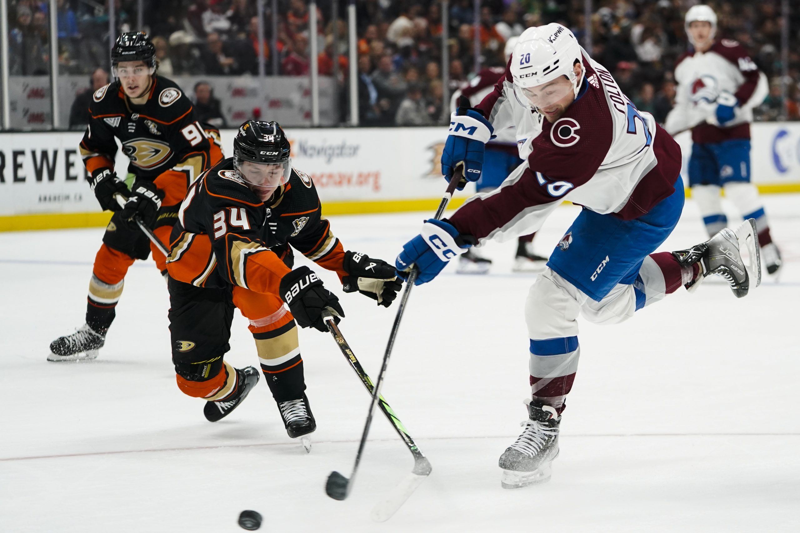 Colorado Avalanche center Ross Colton, right, shoots against Anaheim Ducks...