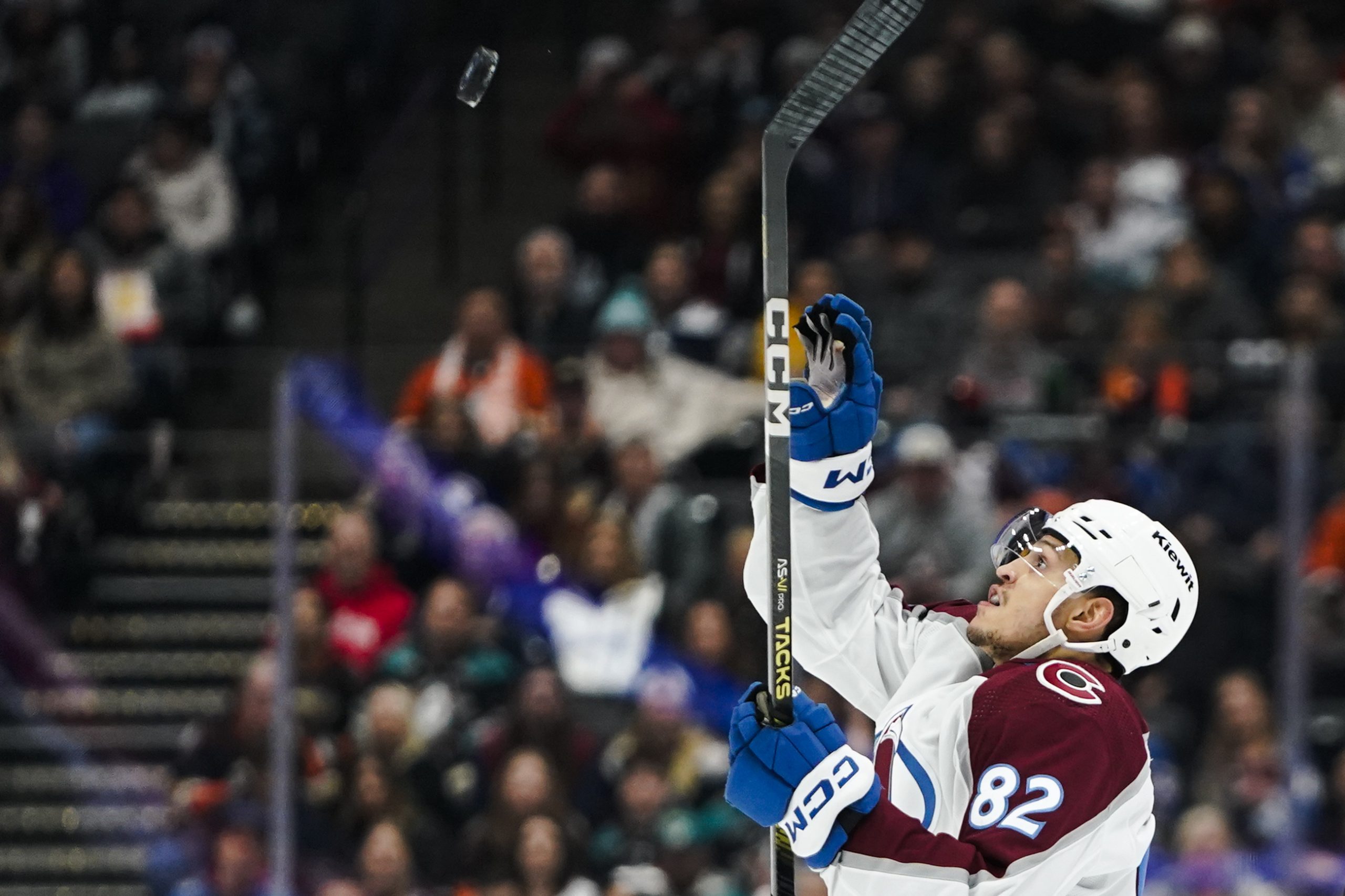 Colorado Avalanche defenseman Caleb Jones prepares to bat an airborne...