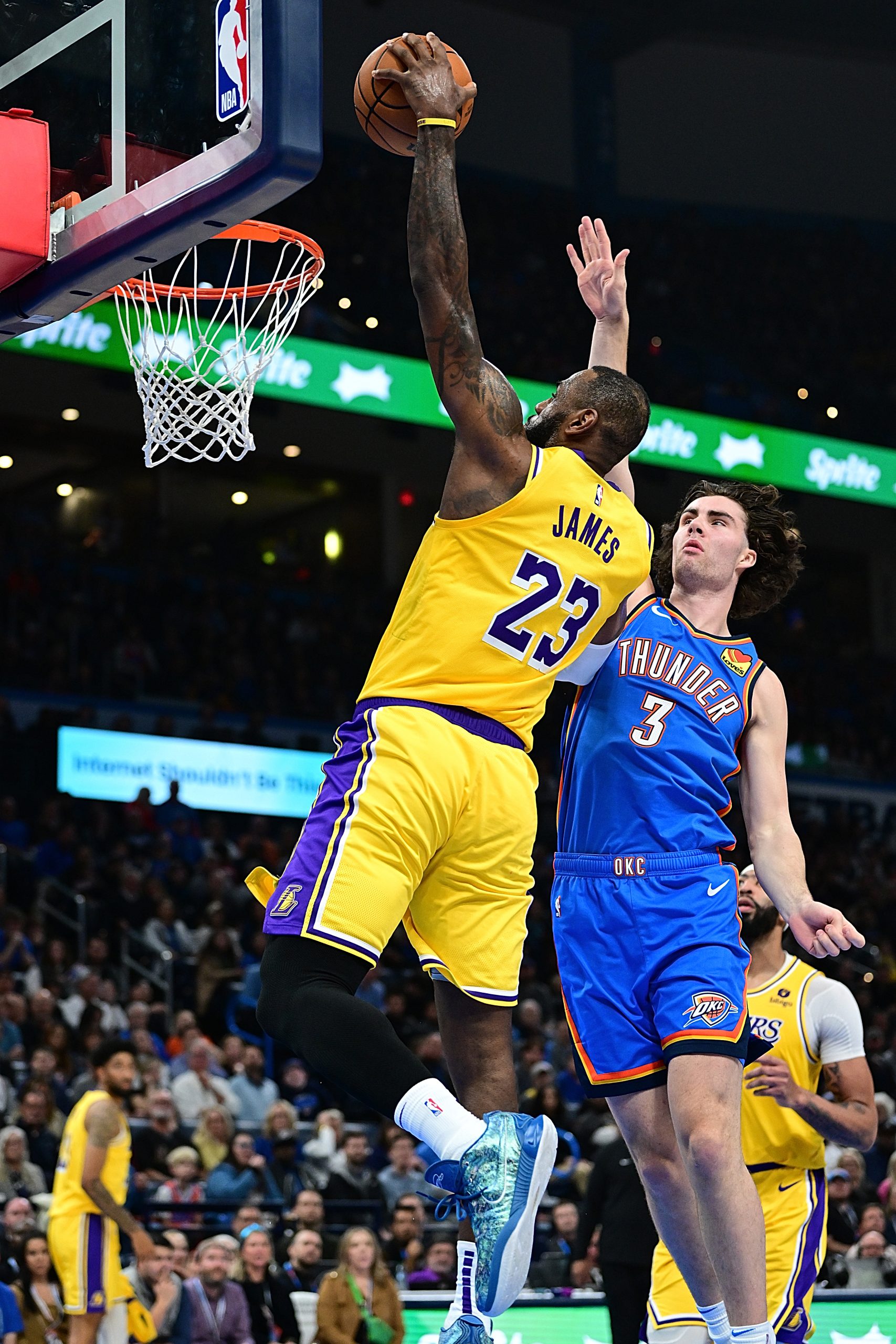 Lakers forward Lebron James goes up for a dunk as...
