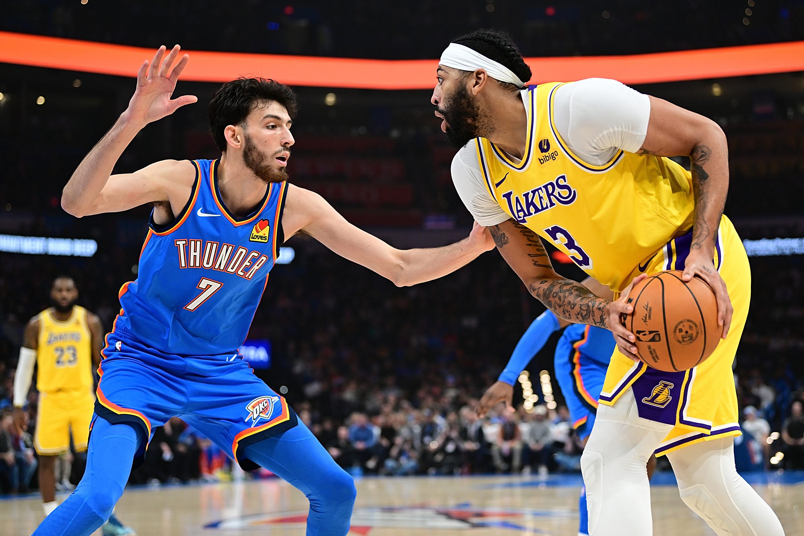 Lakers star Anthony Davis handles the ball while being defended...