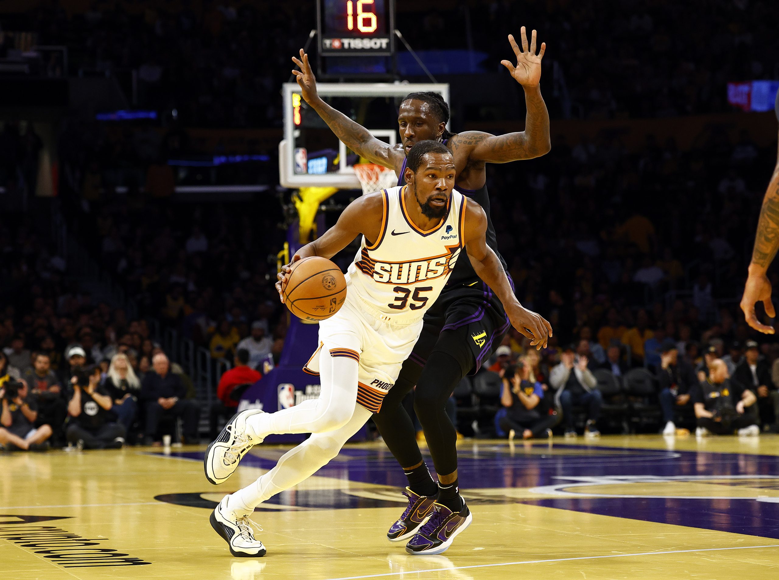 Phoenix Suns forward Kevin Durant drives as the Lakers’ Taurean...