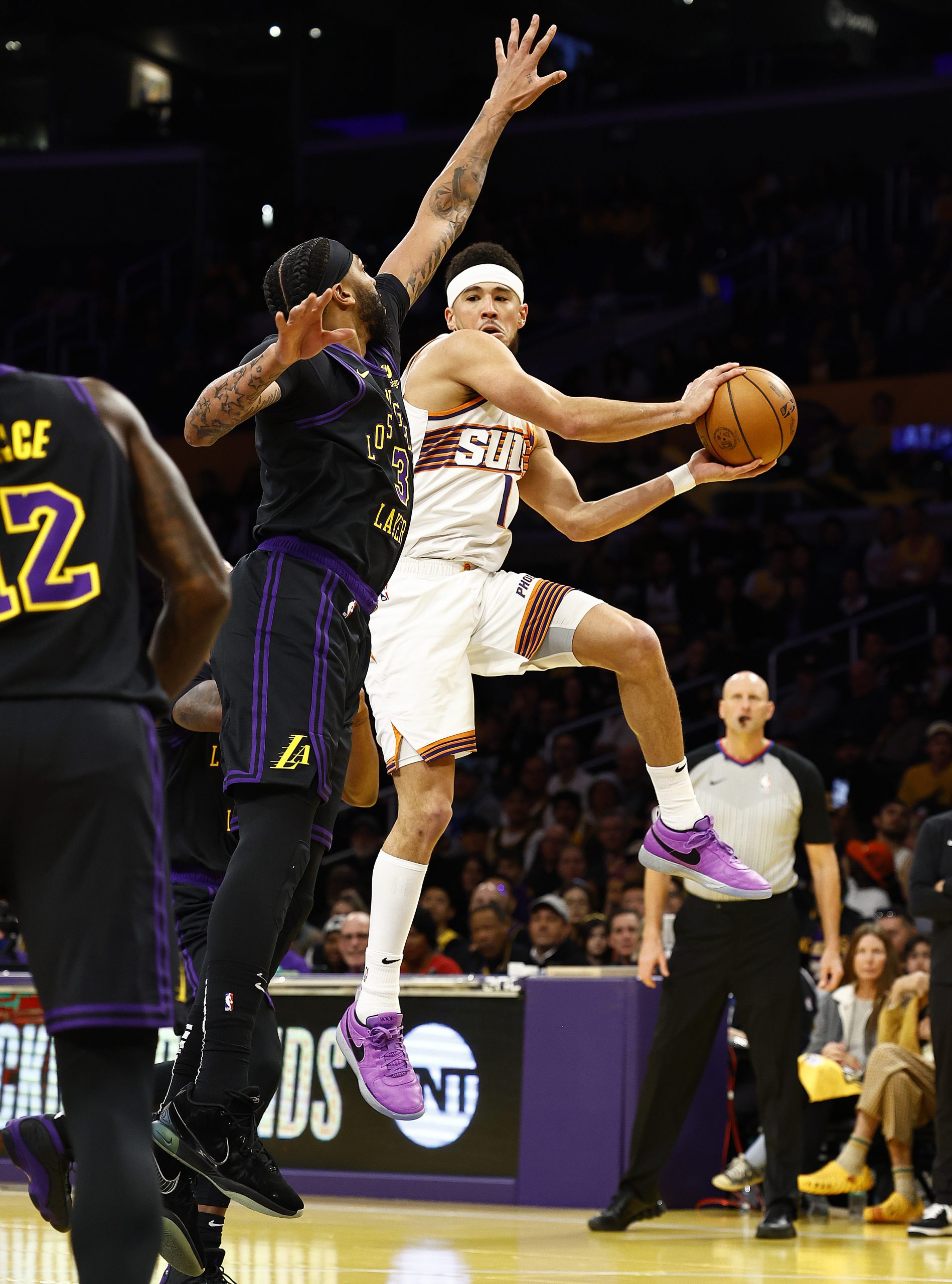 Phoenix Suns guard Devin Booker looks to pass the ball...
