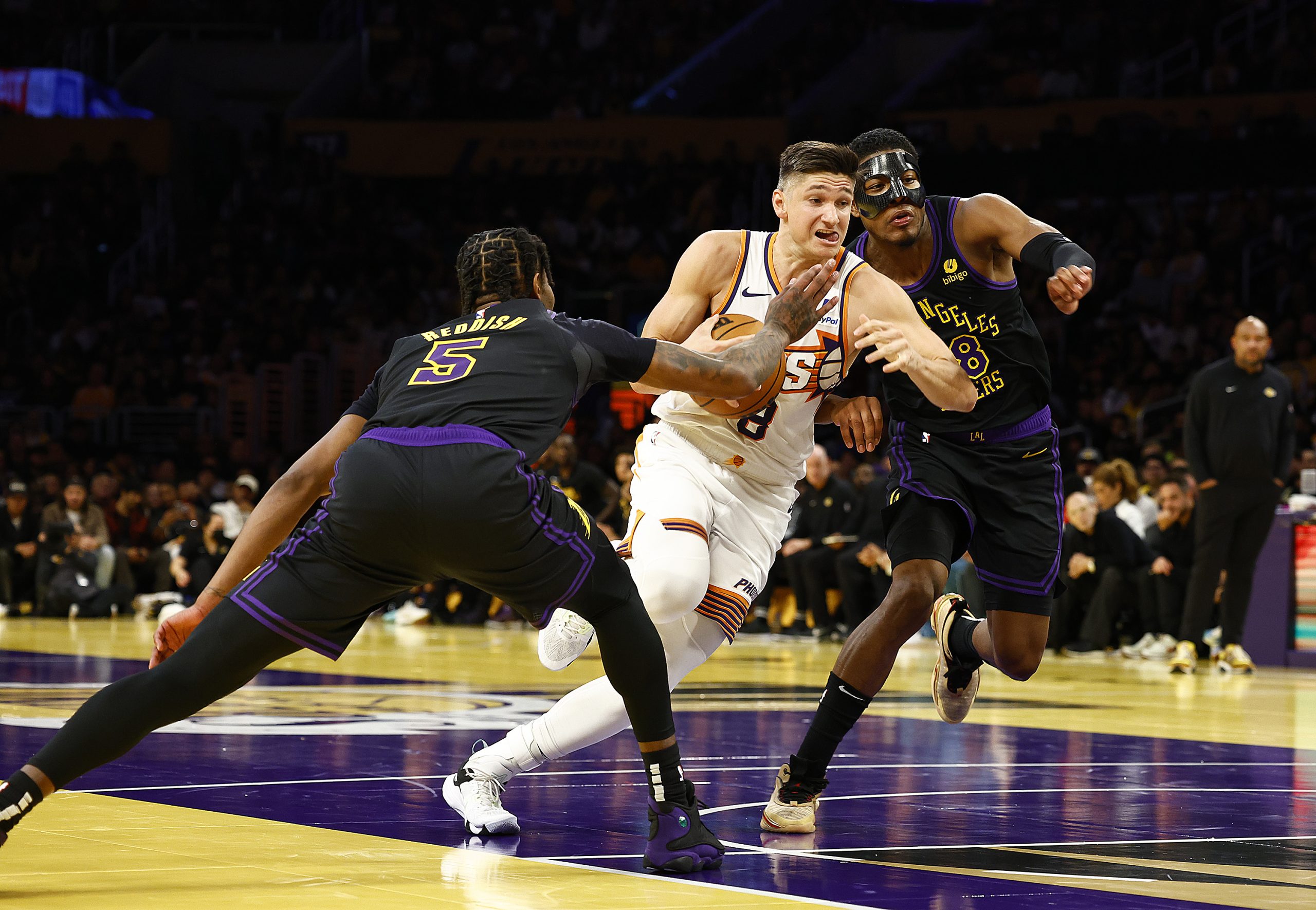 Phoenix Suns guard Grayson Allen drives as Lakers forwards Rui...