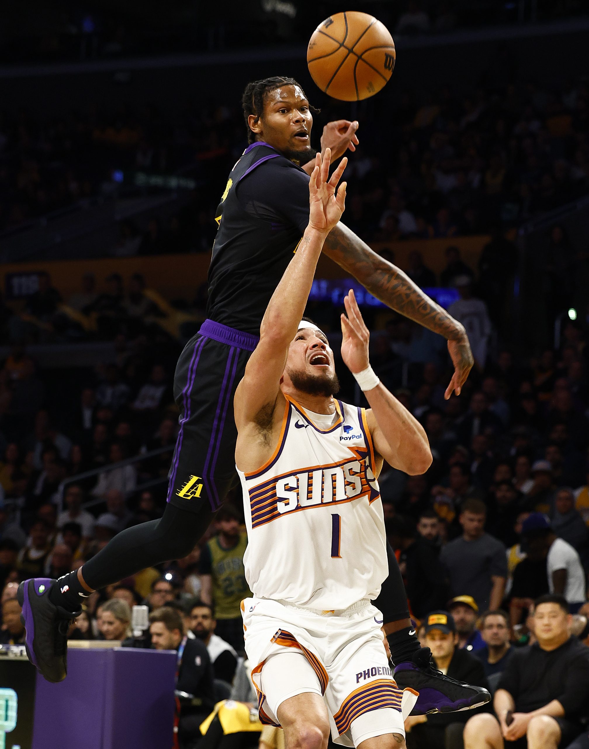 Phoenix Suns guard Devin Booker takes a shot as Lakers...