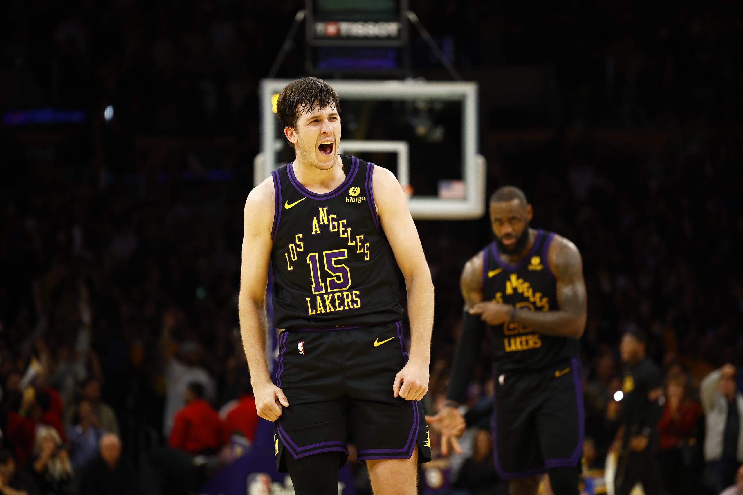 Lakers guard Austin Reaves celebrates after making a 3-point shot...
