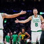 Boston Celtics center Kristaps Porzingis (8) and forward Jayson Tatum (0) react after a play against the Utah Jazz in the second quarter at TD Garden.