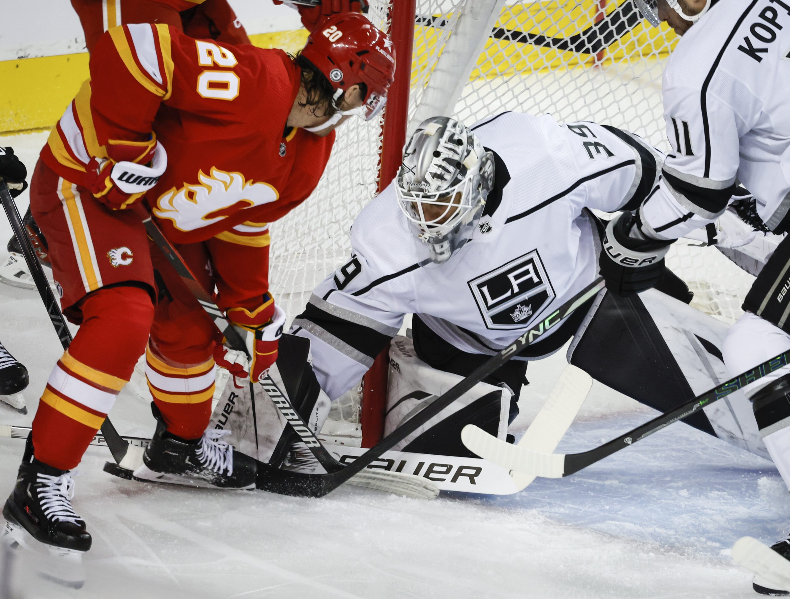 Kings goalie Cam Talbot, right, defends the goal from Calgary...