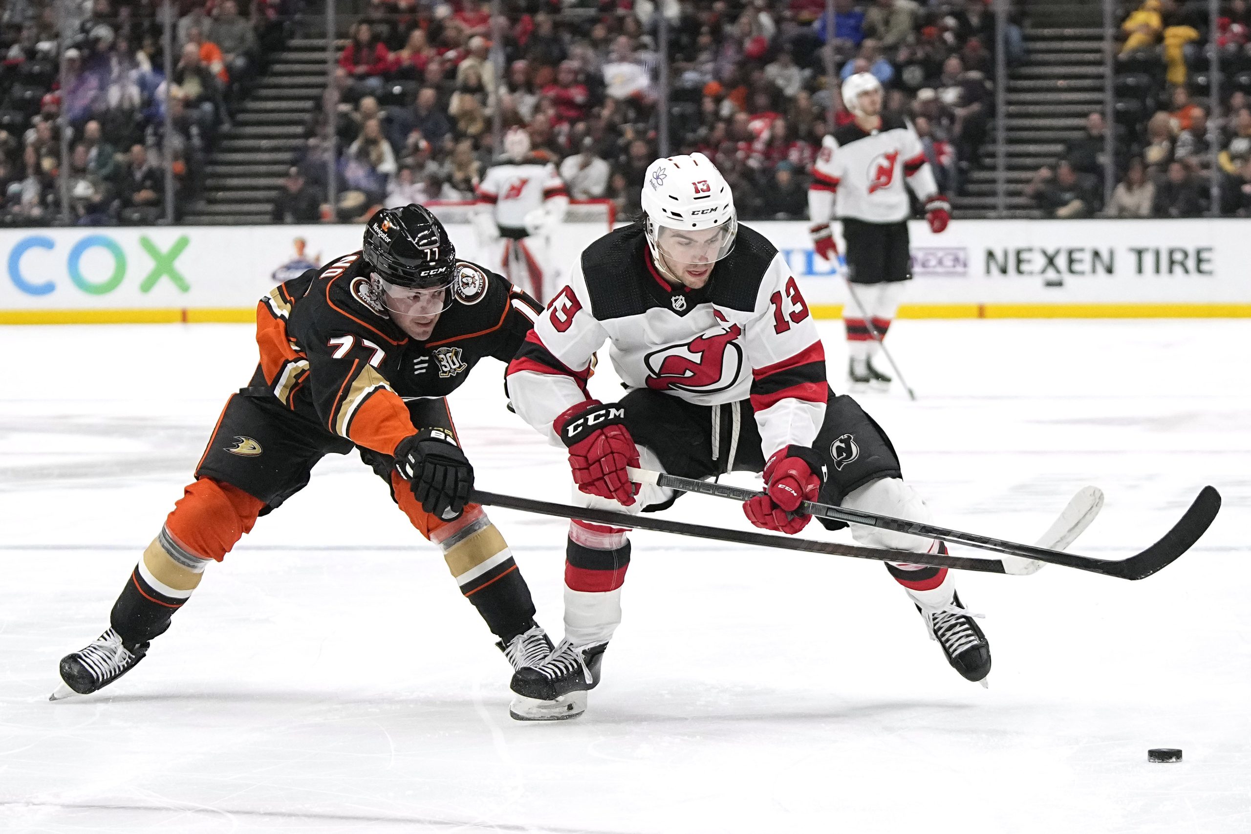 Ducks right wing Frank Vatrano, left, reaches in on New...