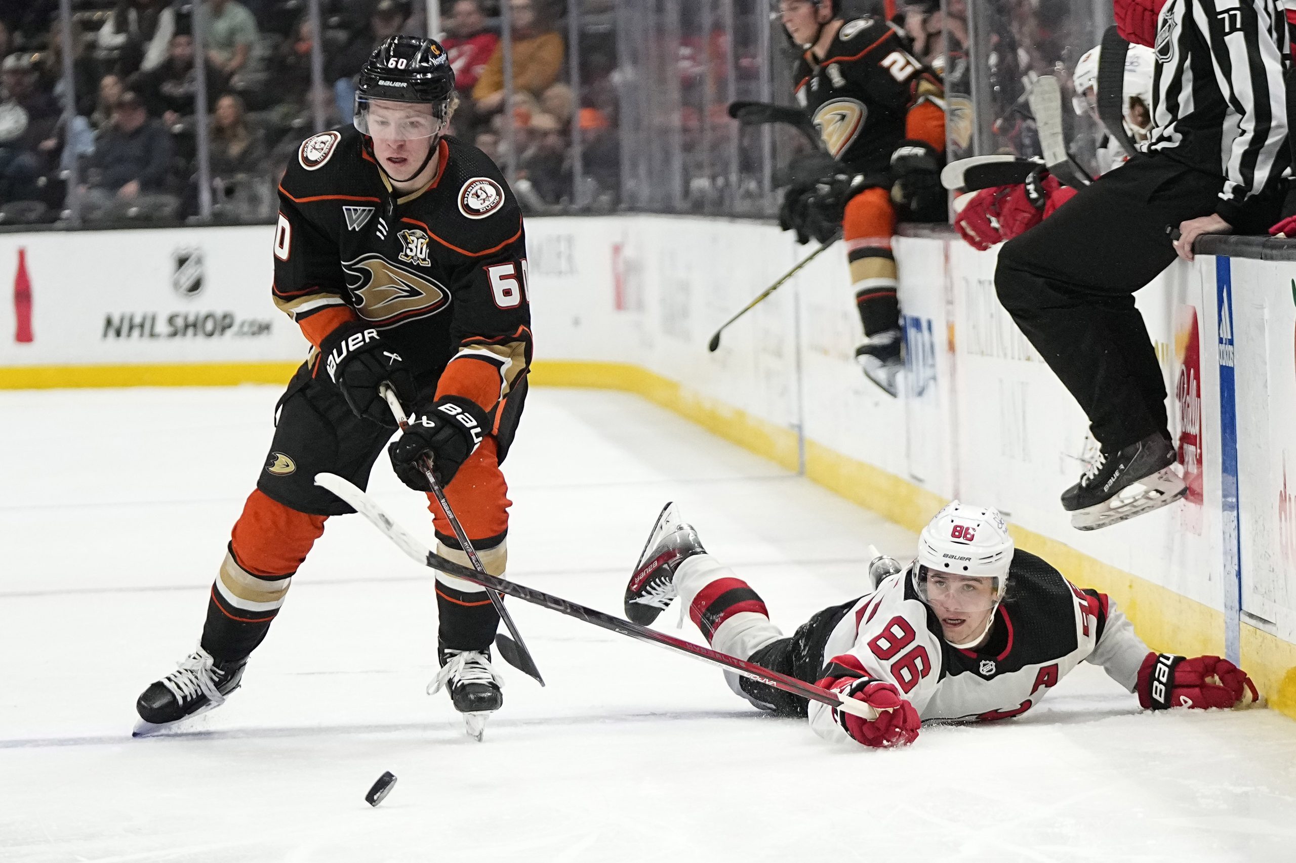 New Jersey Devils center Jack Hughes, right, reaches for the...