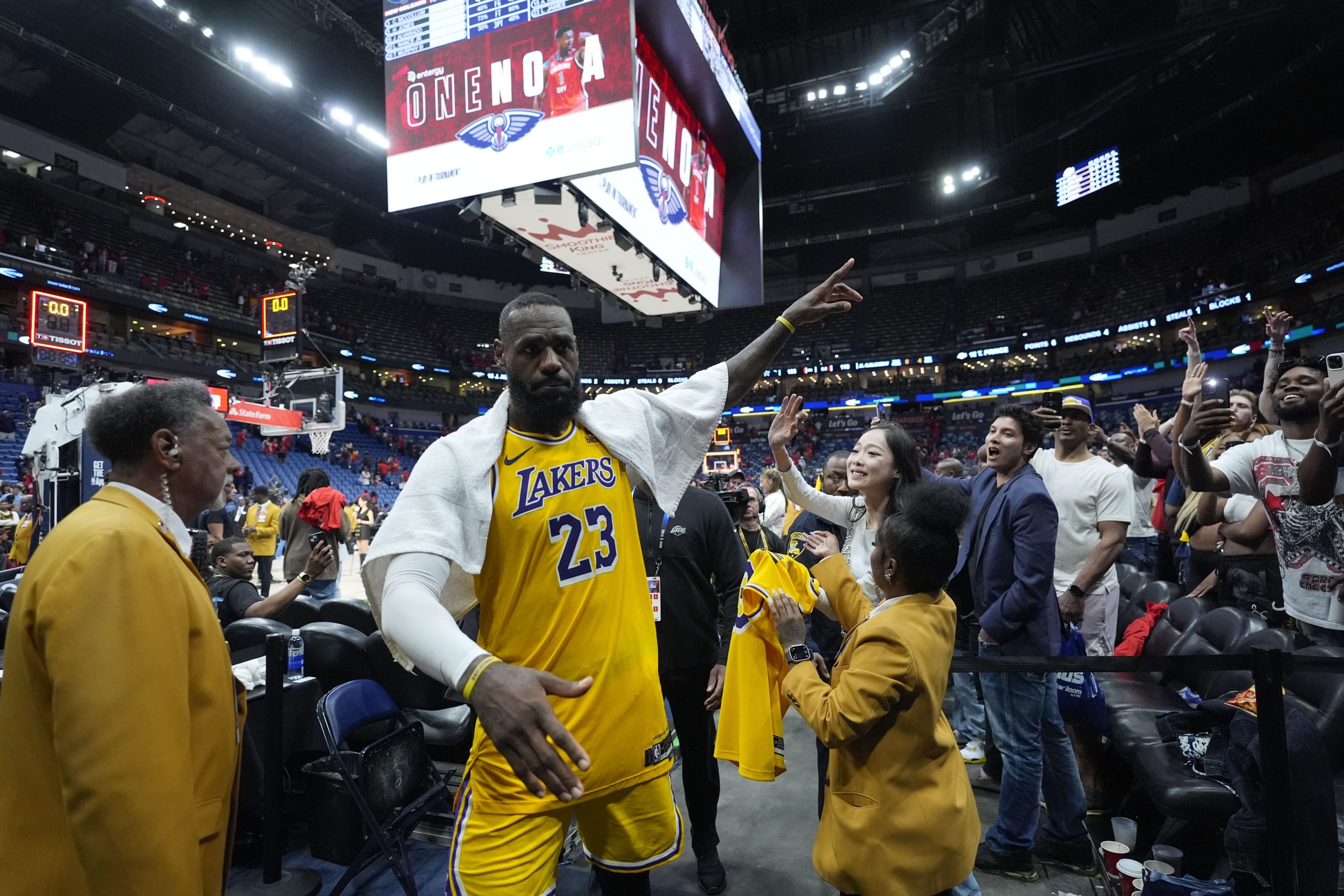 Lakers star LeBron James acknowledges fans as he leaves the...