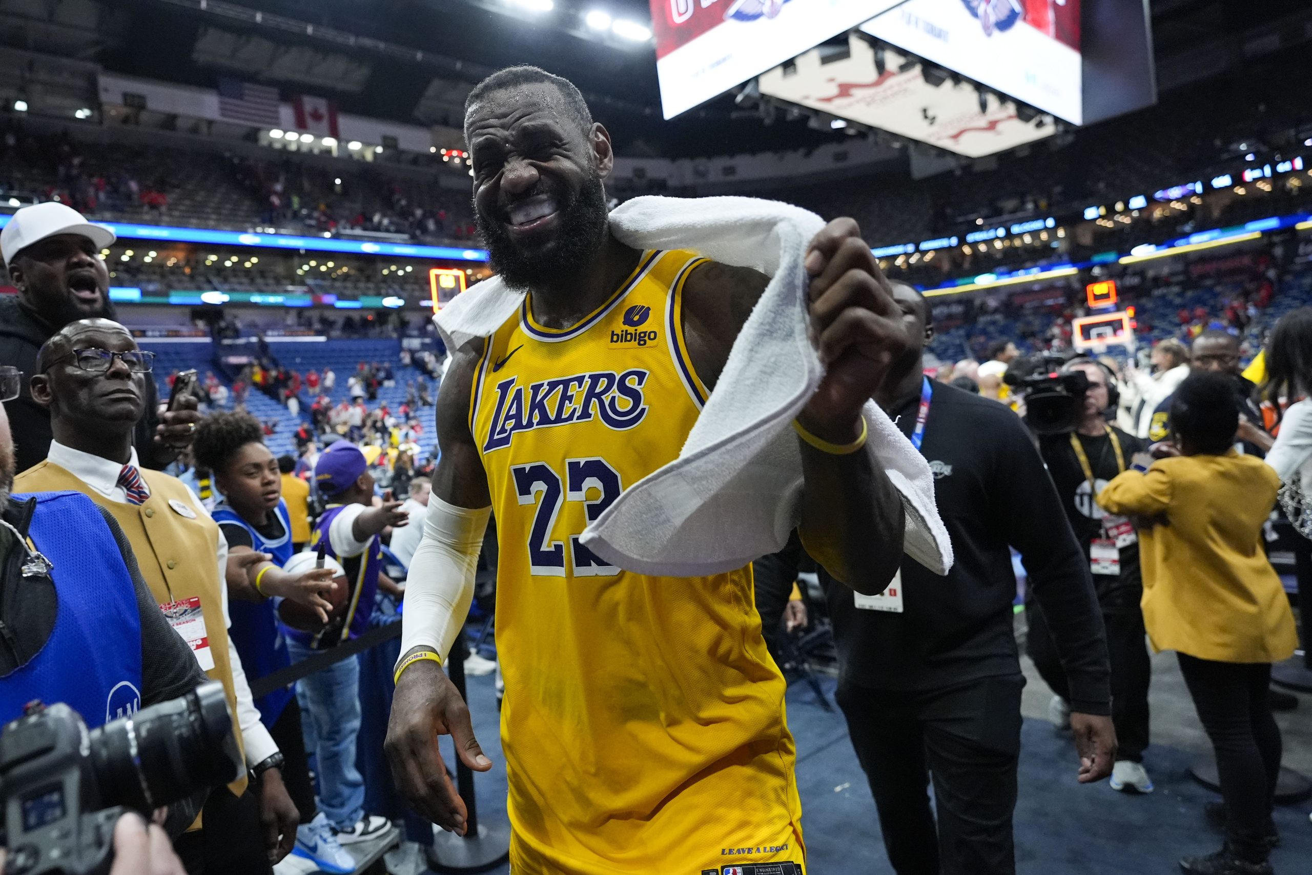 Lakers star LeBron James smiles as he leaves the court...