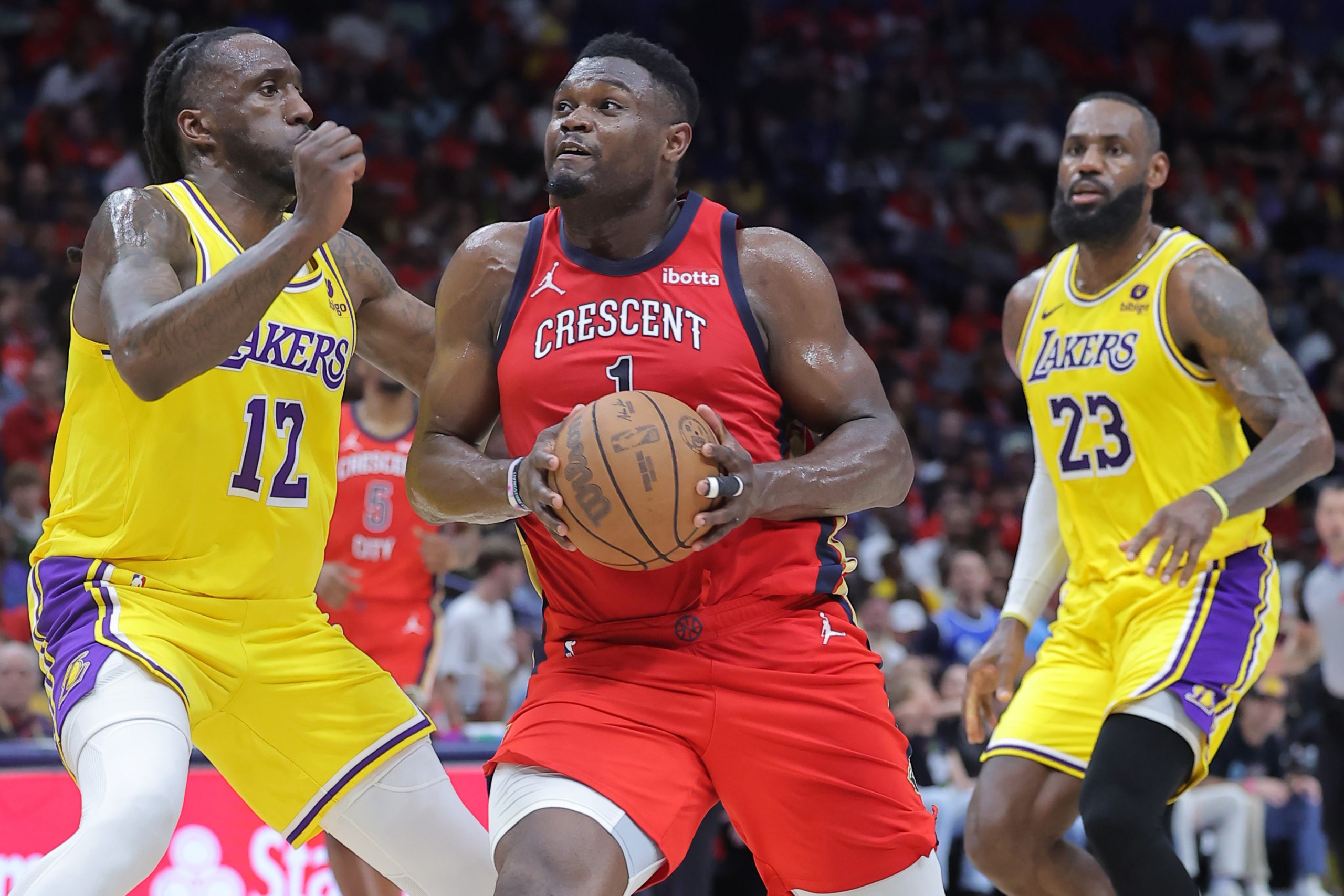 New Orleans Pelicans star Zion Williamson drives against Lakers forwards...