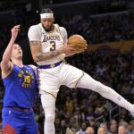 Mar 2, 2024; Los Angeles, California, USA; Los Angeles Lakers forward Anthony Davis (3) grabs a rebound in front of Denver Nuggets center Nikola Jokic (15) in the first half at Crypto.com Arena. Mandatory Credit: Jayne Kamin-Oncea-USA TODAY Sports
