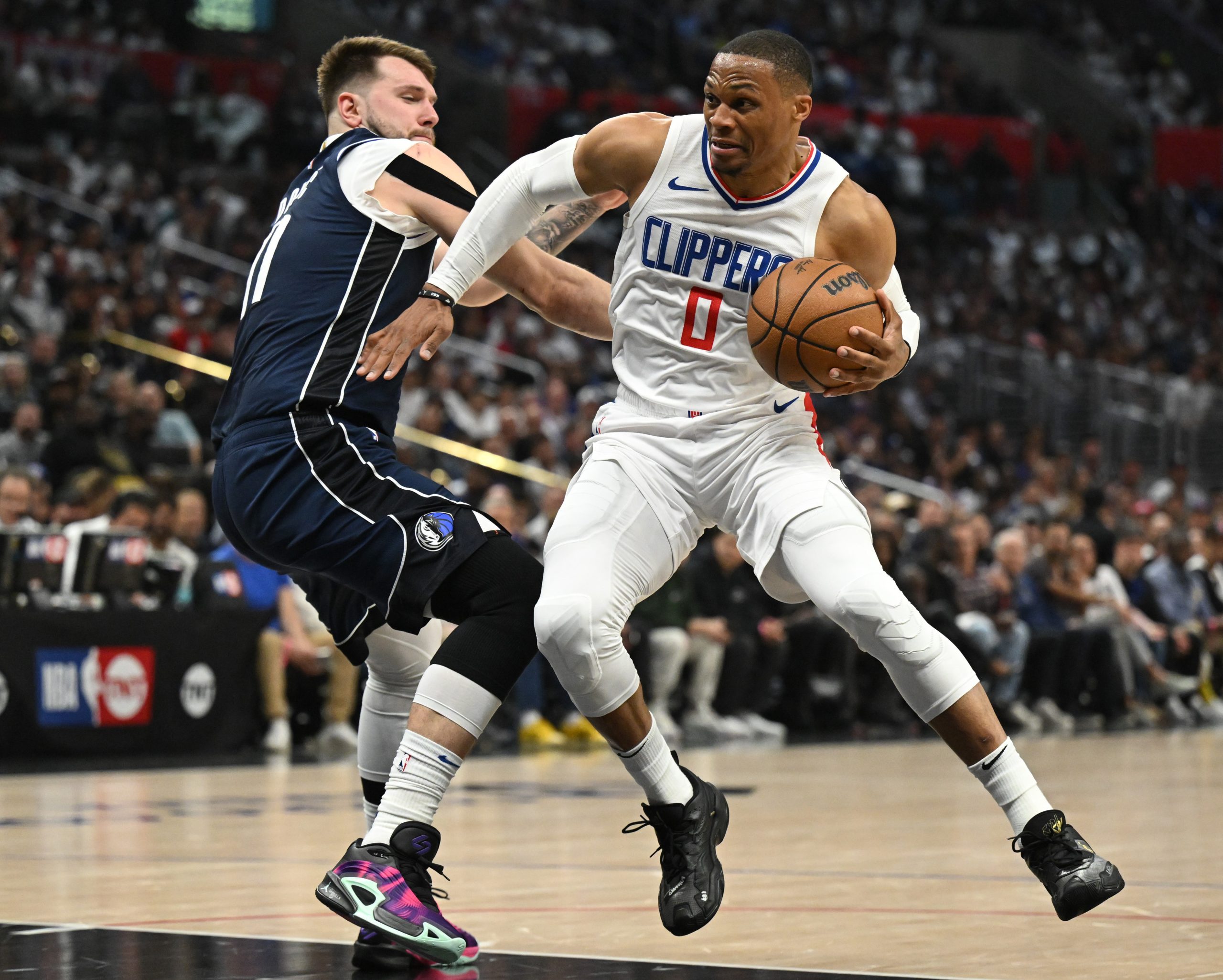 Clippers guard Russell Westbrook looks for a path around Dallas...