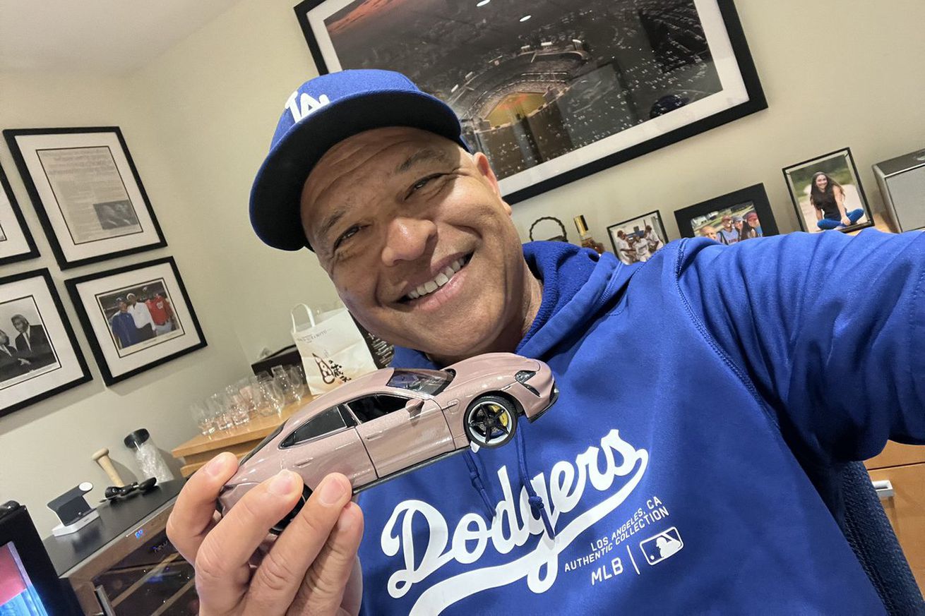 Dave Roberts shows the (model) Porsche that Shohei Ohtani bought him after tying his Dodgers record for home runs by a player born in Japan.