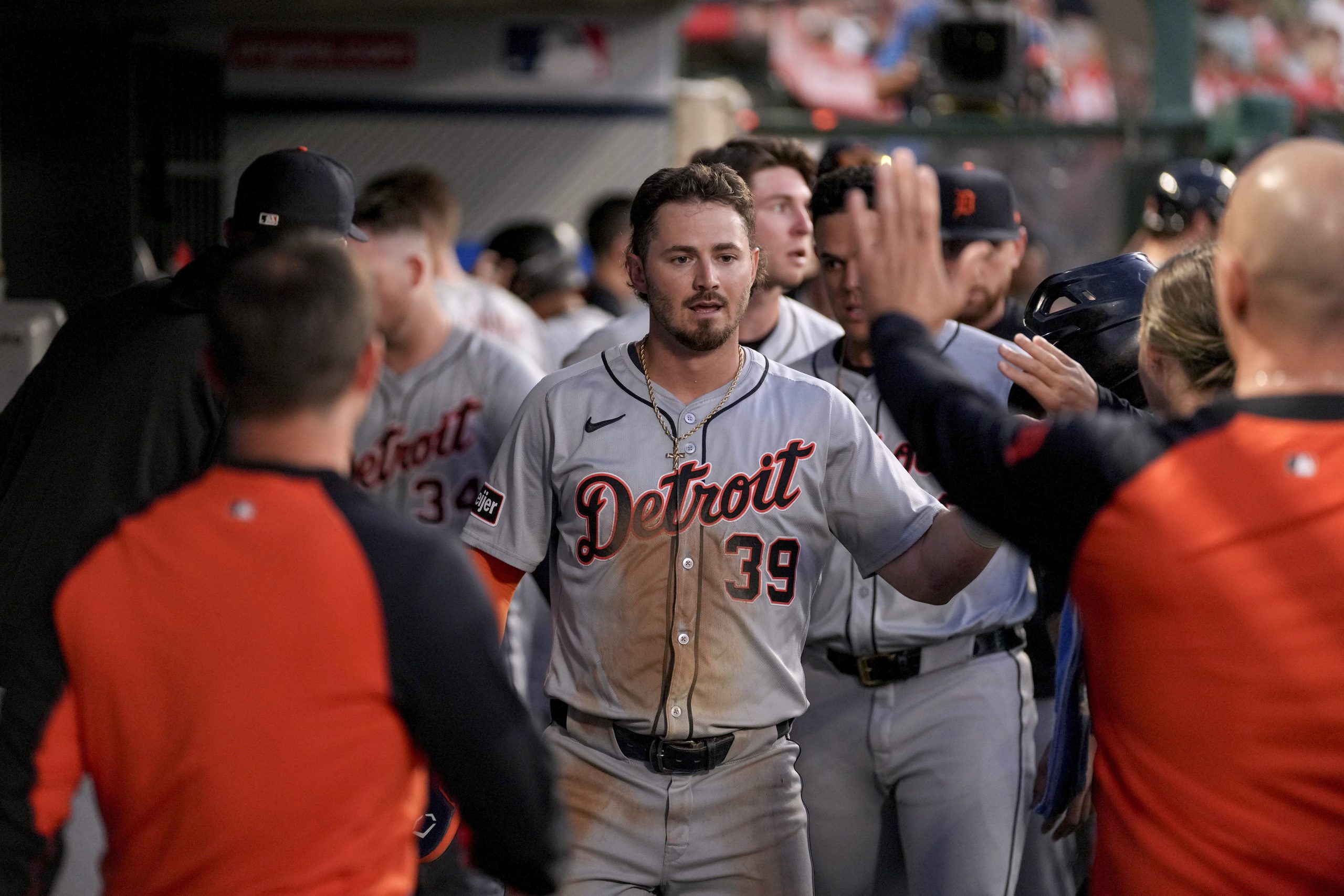 Detroit Tigers’ Zach McKinstry (39) is congratulated in the dugout...