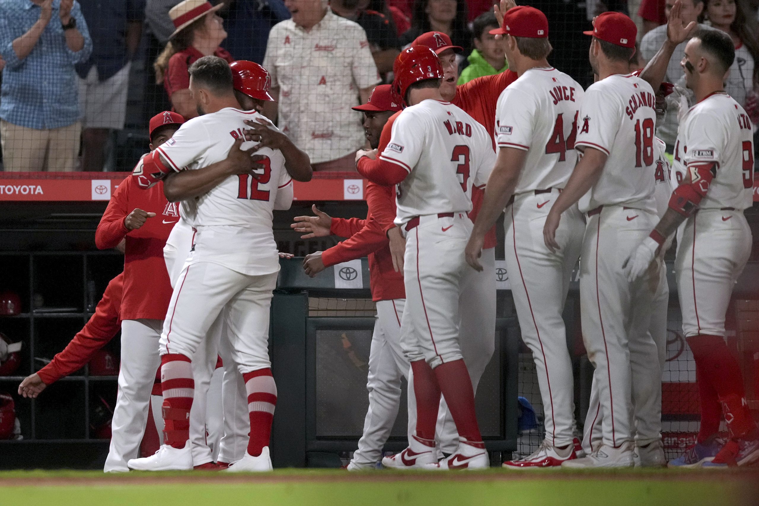 Los Angeles Angels designated hitter Kevin Pillar (12) is congratulated...