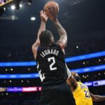 Los Angeles Clippers forward Kawhi Leonard (2) shoots against Los Angeles Lakers forward LeBron James (23)