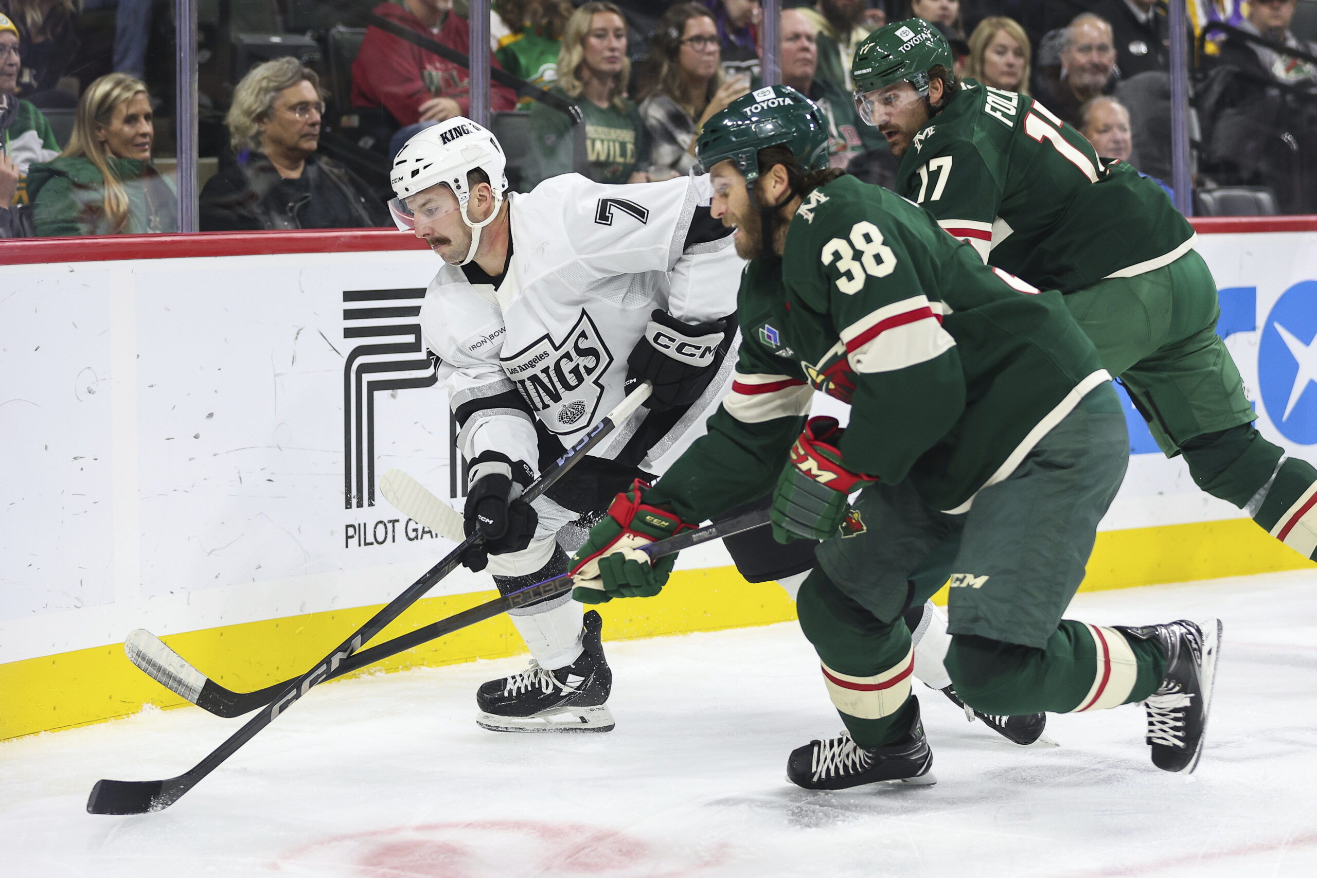 Kings defenseman Kyle Burroughs, left, and Minnesota Wild right wing...