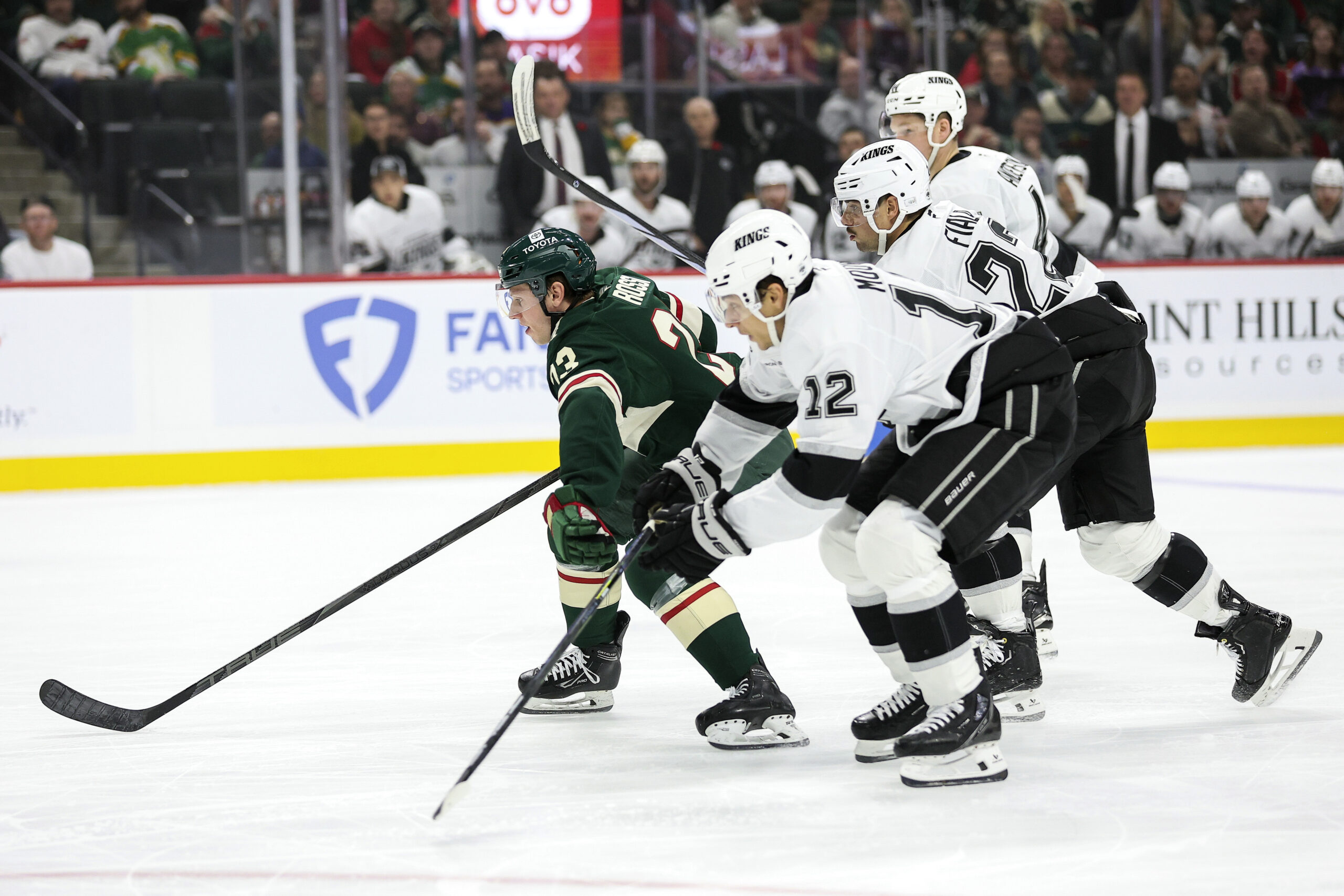 Minnesota Wild center Marco Rossi, left, competes for position with...