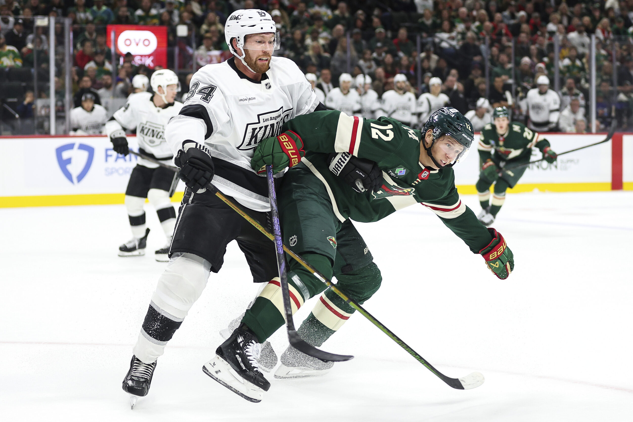 Kings defenseman Vladislav Gavrikov, left, and Minnesota Wild left wing...