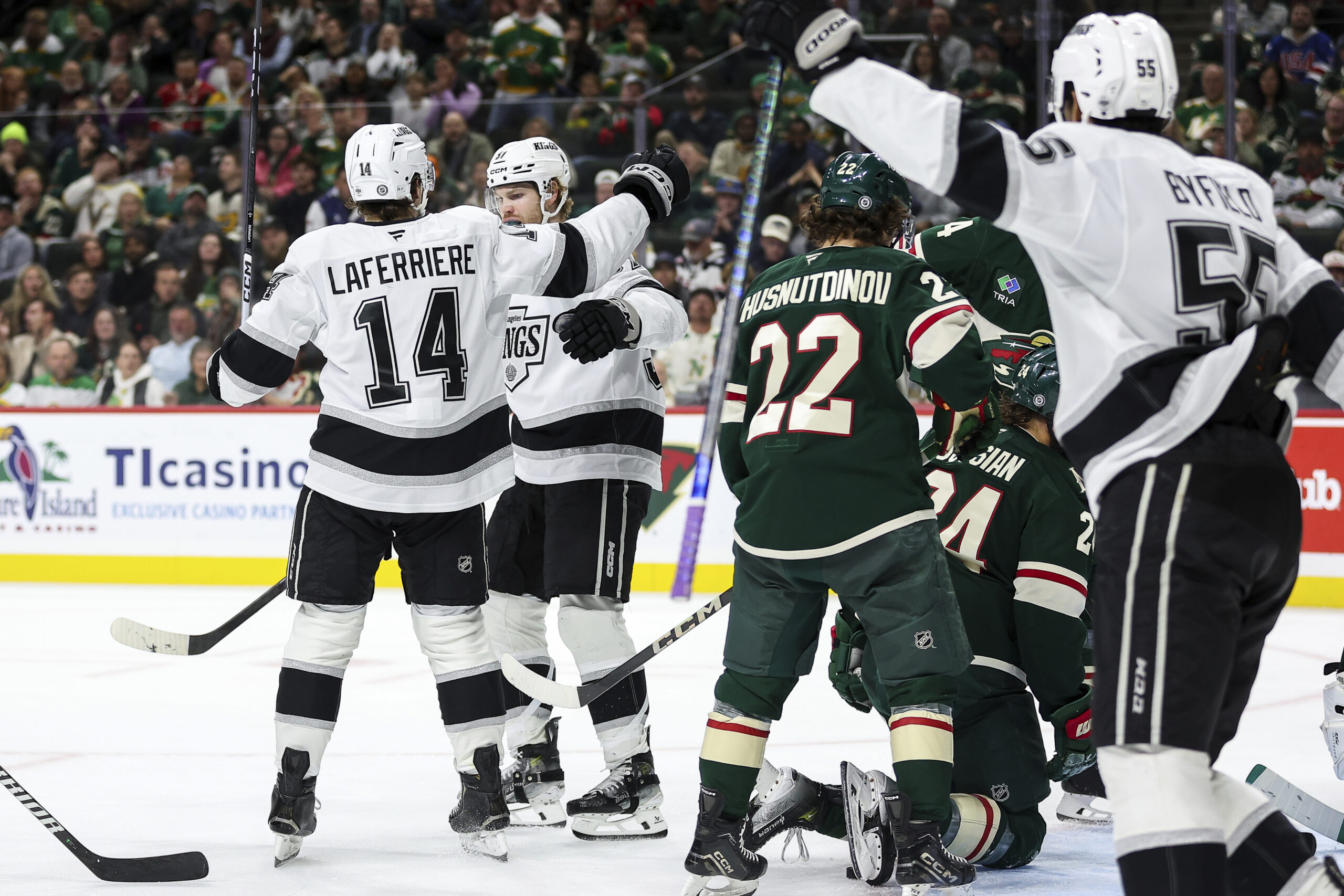 Kings left wing Warren Foegele, middle, celebrates his goal during...