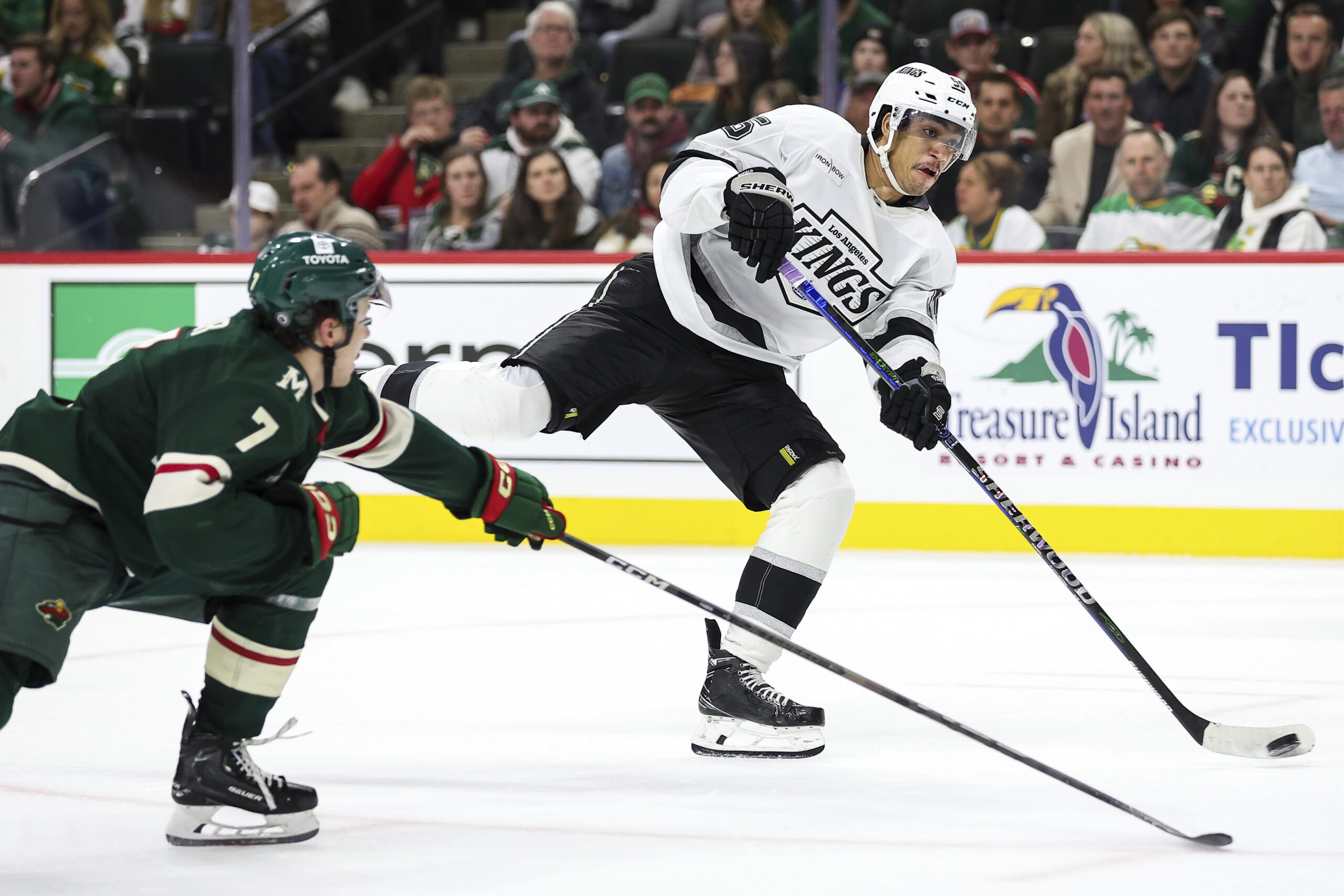 Kings right wing Quinton Byfield, right, shoots as Minnesota Wild...