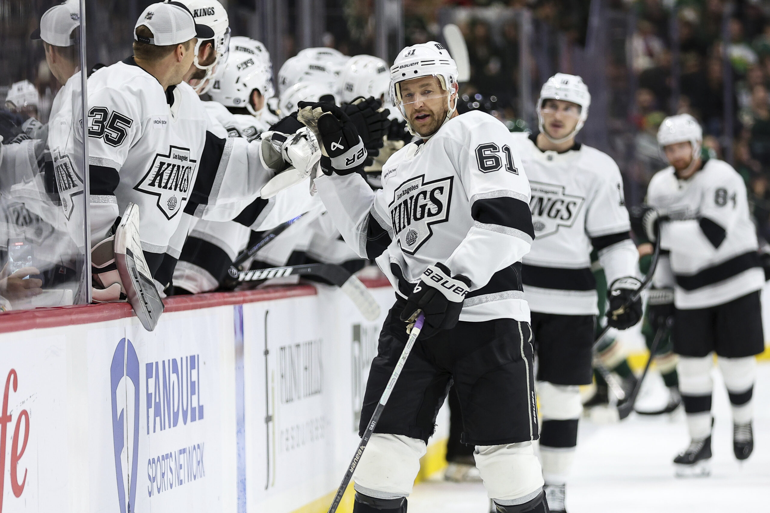 Kings center Trevor Lewis is congratulated for his goal as...