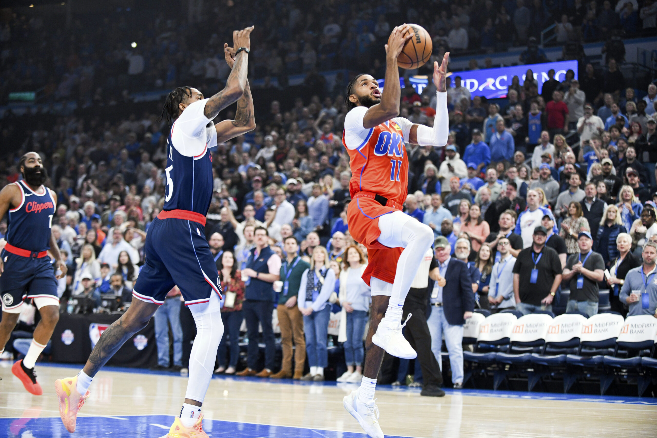 Oklahoma City Thunder guard Isaiah Joe, right, shoots around Clippers...