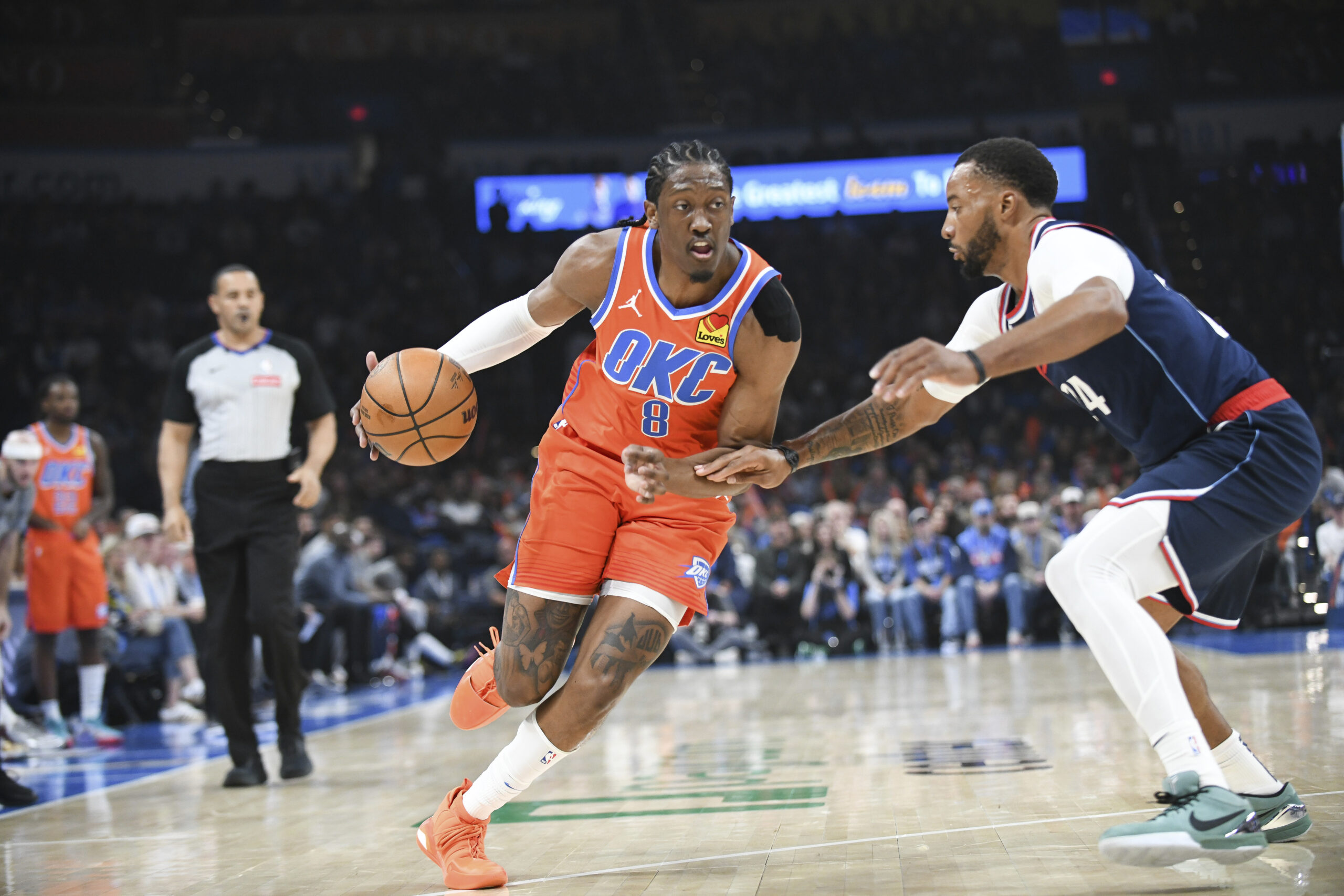 Oklahoma City Thunder forward Jalen Williams, left, drives past Clippers...