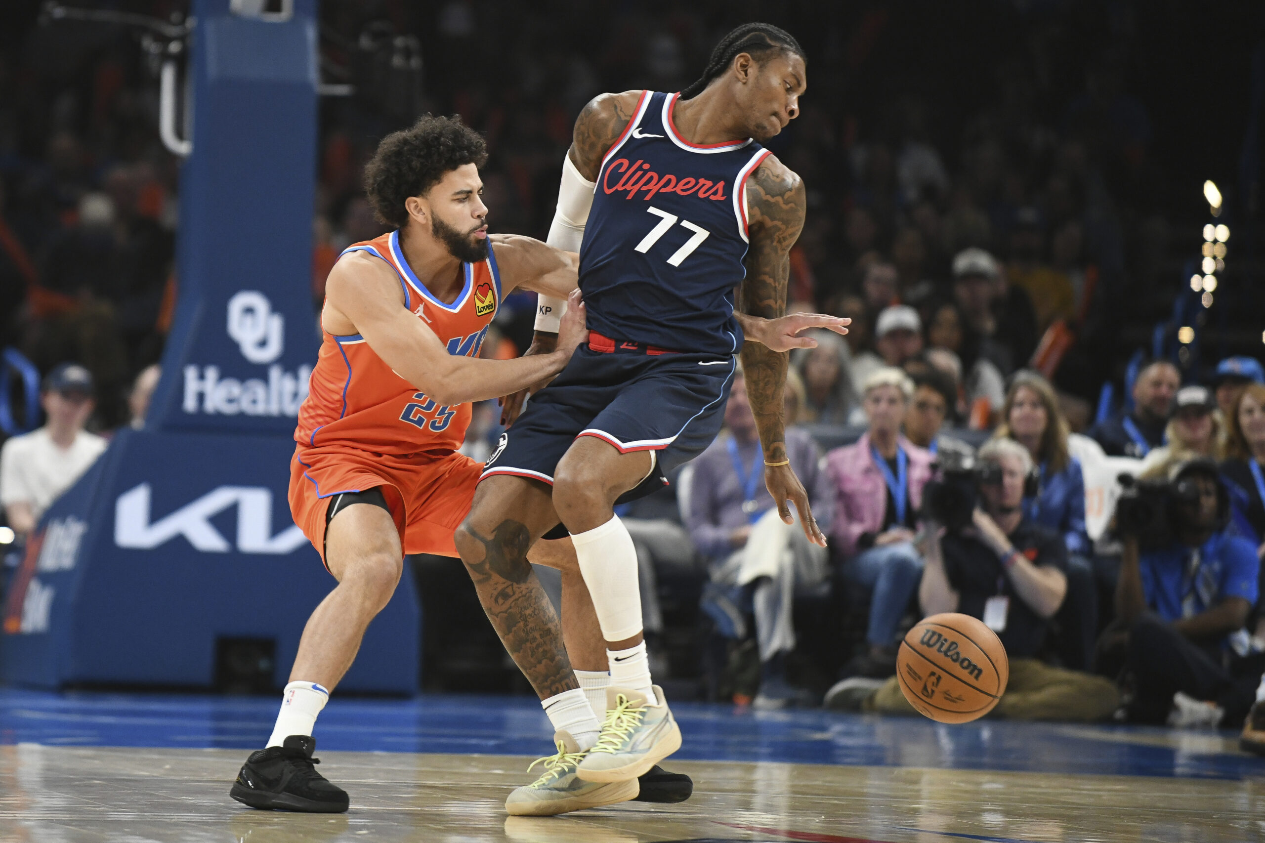 Oklahoma City Thunder guard Ajay Mitchell, left, tries to steal...